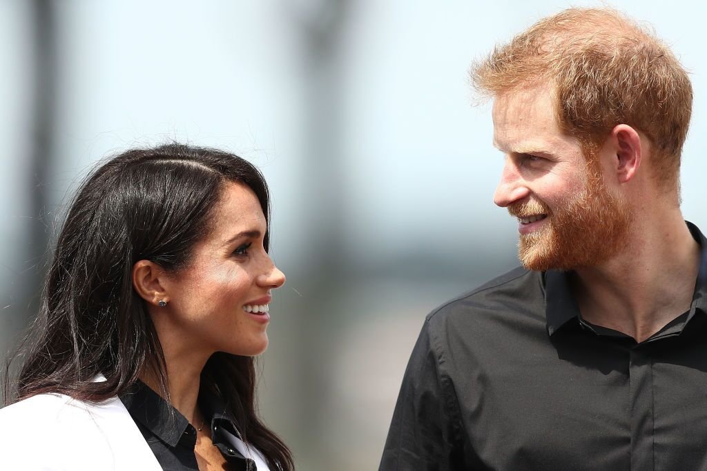 Prince Harry, Duke of Sussex and Meghan, Duchess of Sussex look at eachother during the JLR Drive Day at Cockatoo Island in Sydney, Australia | Photo: Getty Images