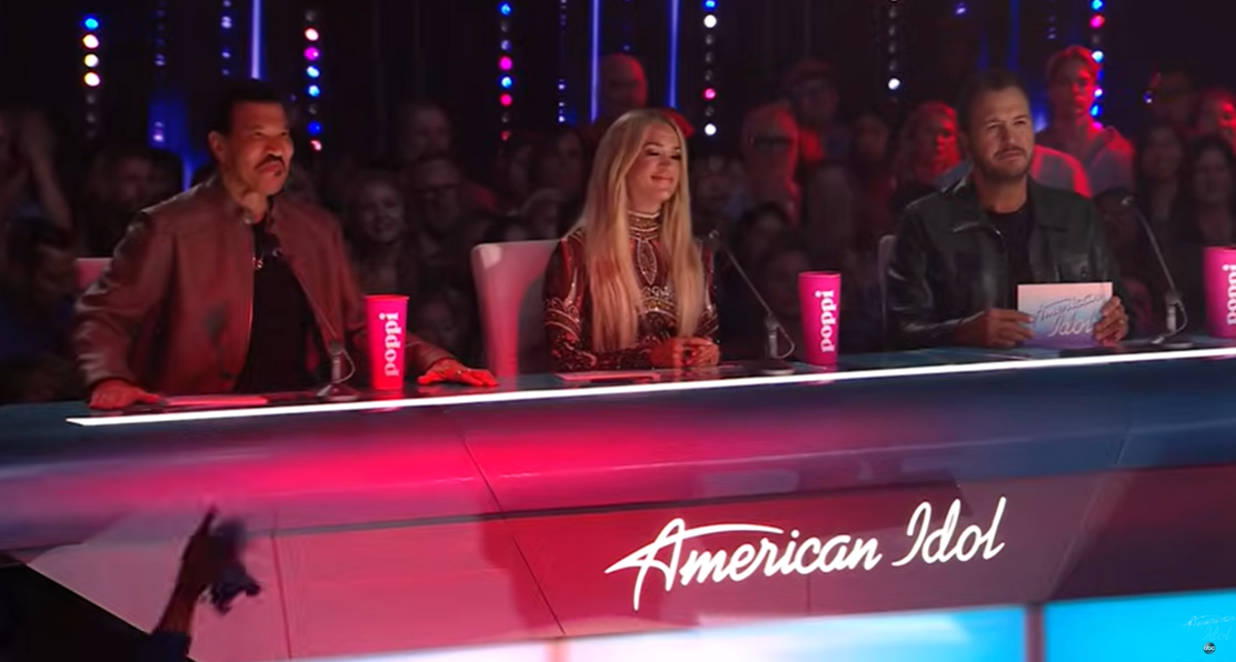 Luke Bryan appears focused while seated alongside Lionel Richie and Carrie Underwood during the American Idol "Ladies' Night" episode | Source: YouTube/AmericanIdol