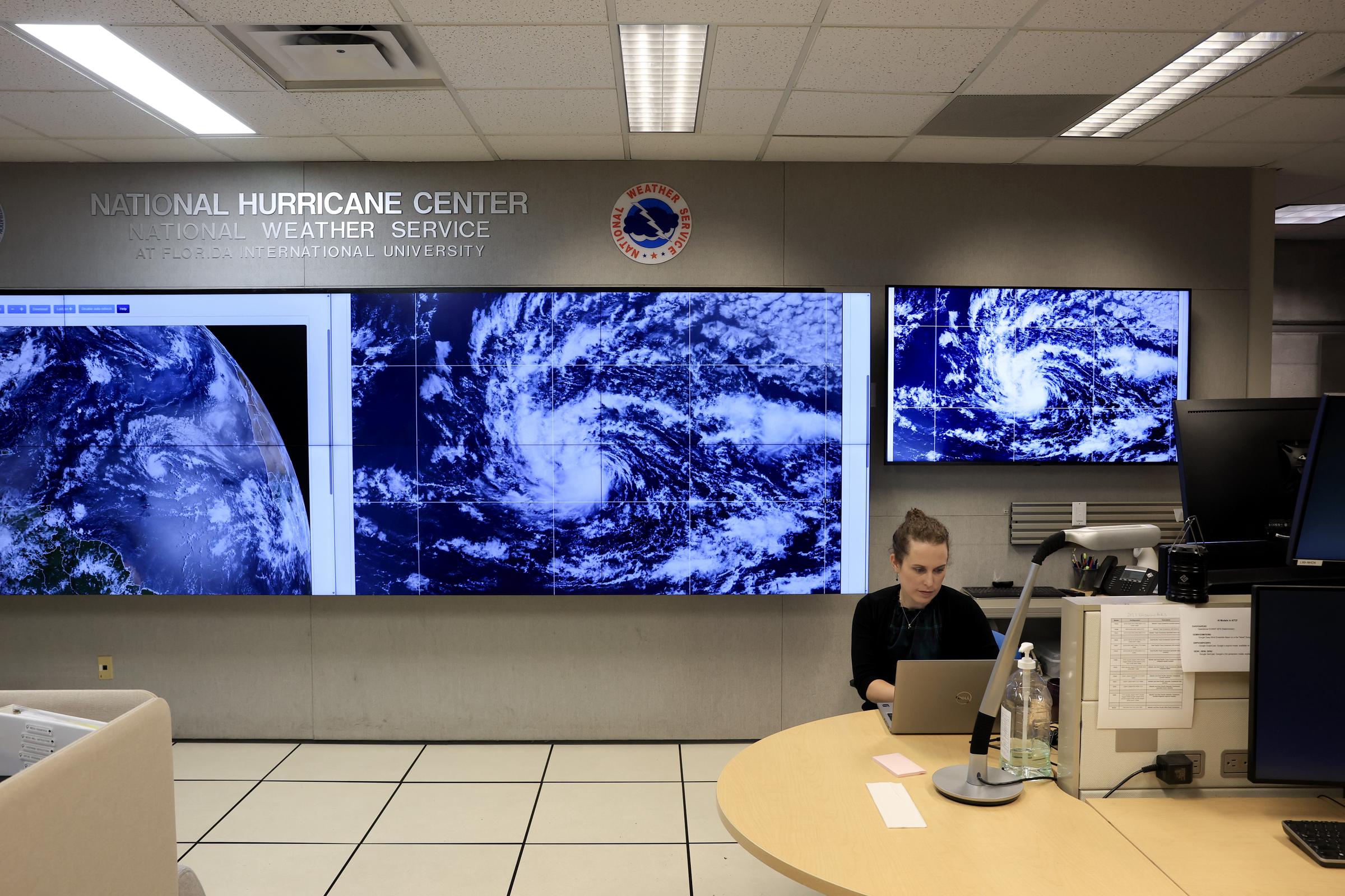 Hurricane Specialist Lissa Bucci at the National Hurricane Center in Miami monitors satellite imagery of Hurricane Erin as the storm develops in the Atlantic, August 13, 2025 | Source: Getty Images
