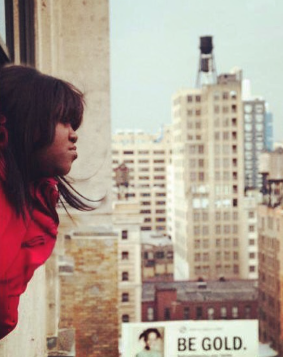The actress looks out over the city as a teen, capturing a quiet, reflective moment | Source: Instagram/gabbysidibe