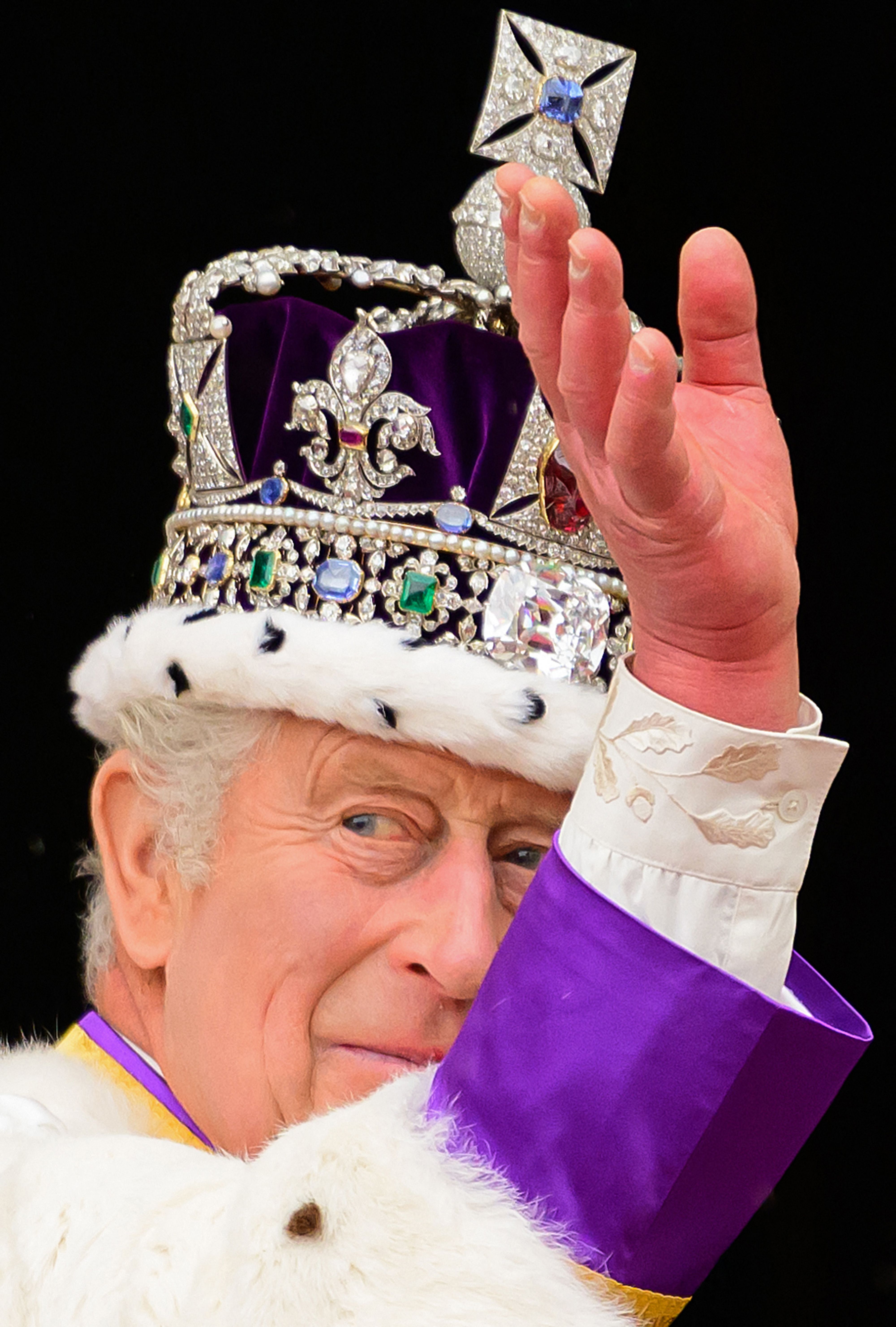 Britain's King Charles III wearing the Imperial state Crown, waves from the Buckingham Palace balcony on May 6, 2023, after his coronation.  | Source: Getty Images