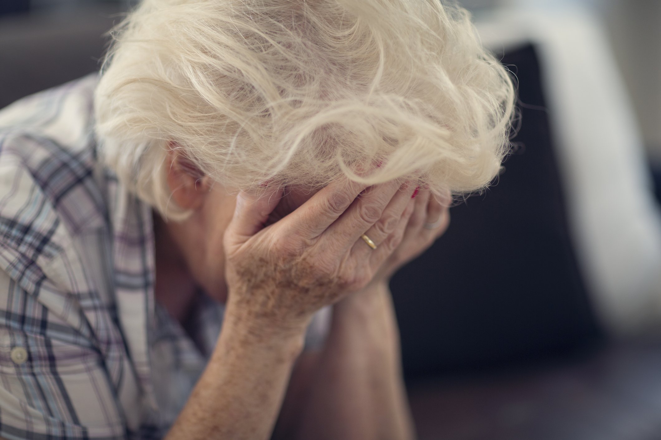 Senior woman buries her face in her hands in despair | Photo: Getty Images 