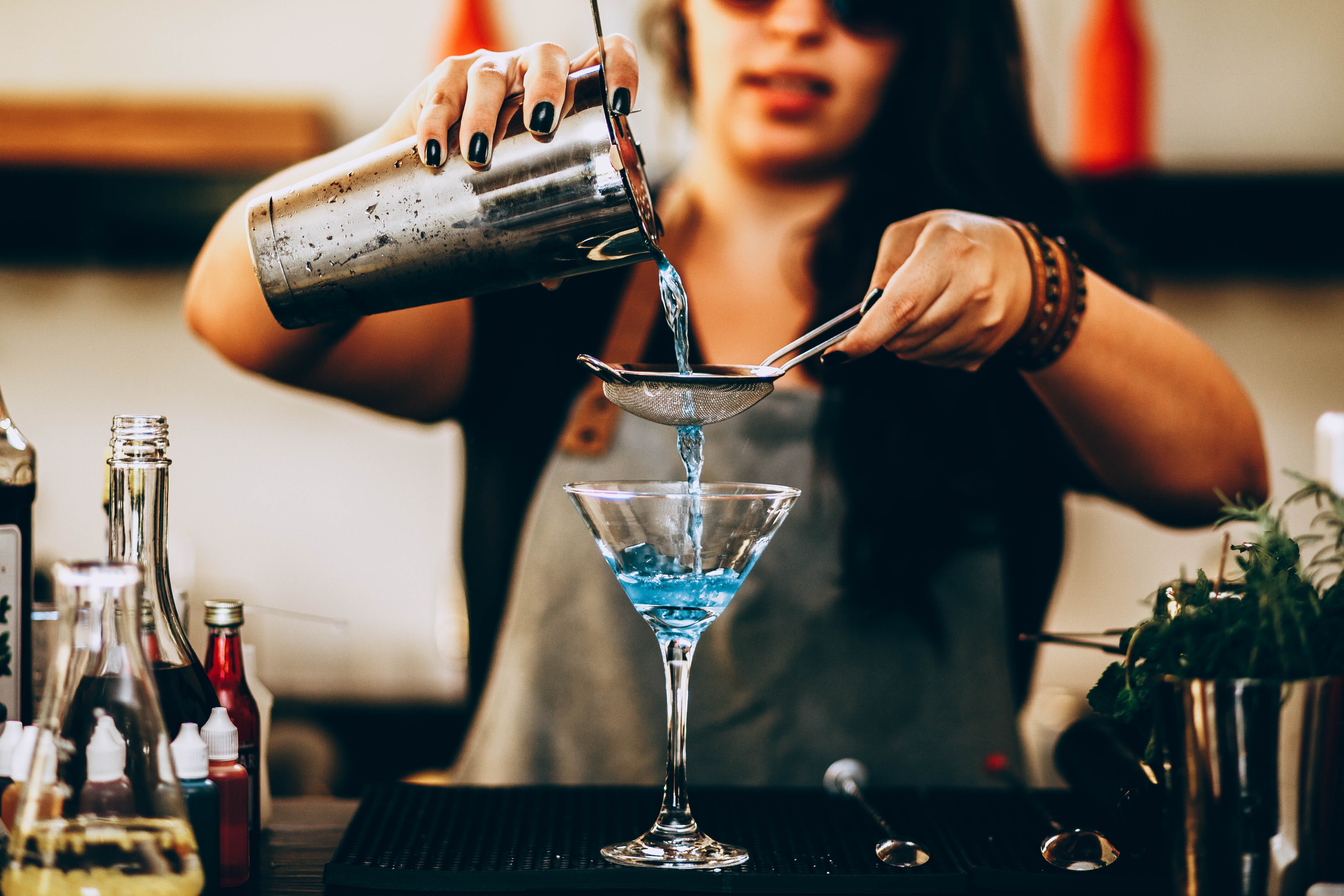 Woman pouring liquid from drink mixer | Source: Pexels