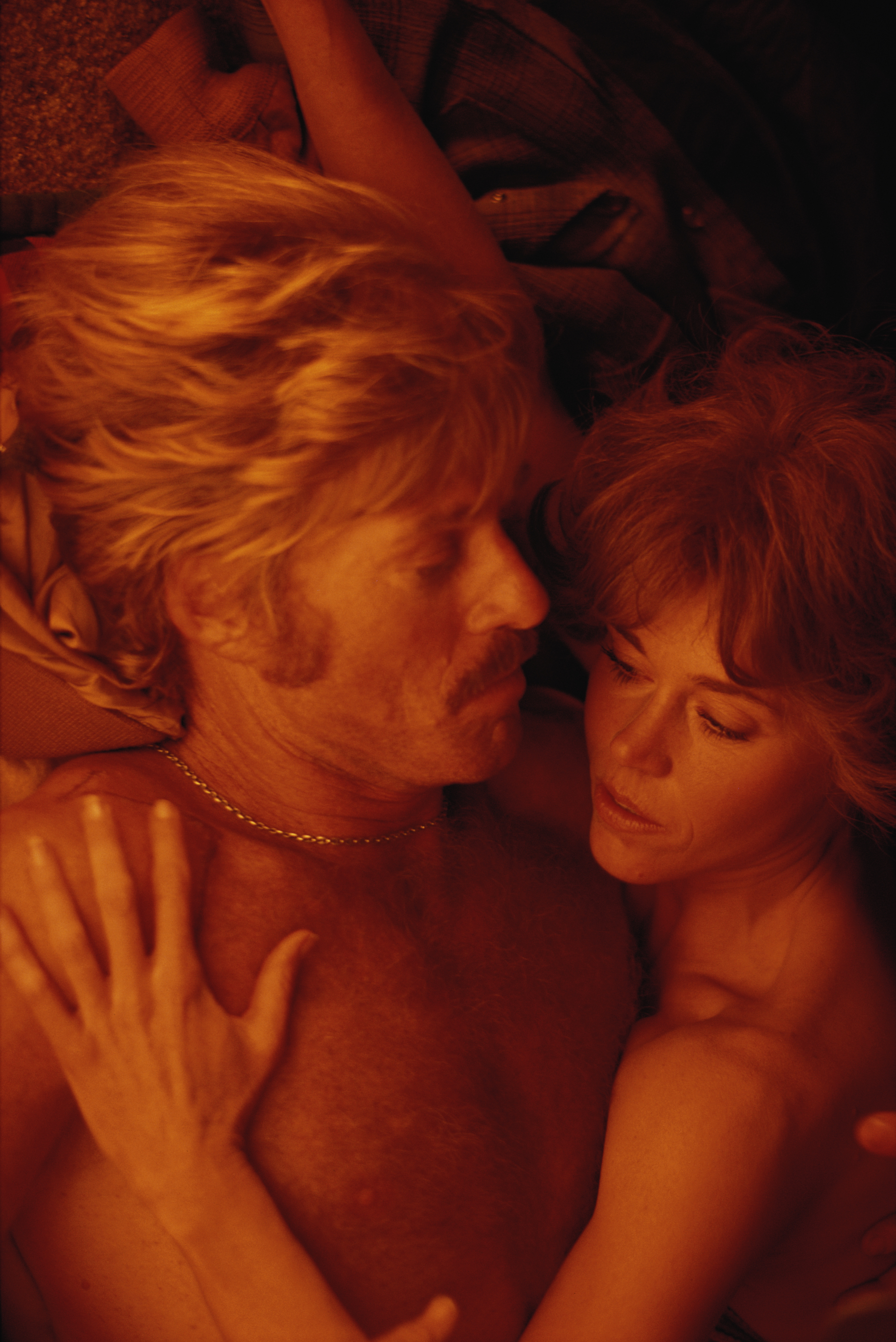 Robert Redford and Jane Fonda on the set of the film "The Electric Horseman." The shot captures them as two lovers lying in bed, peaceful and relaxed in each other’s arms.