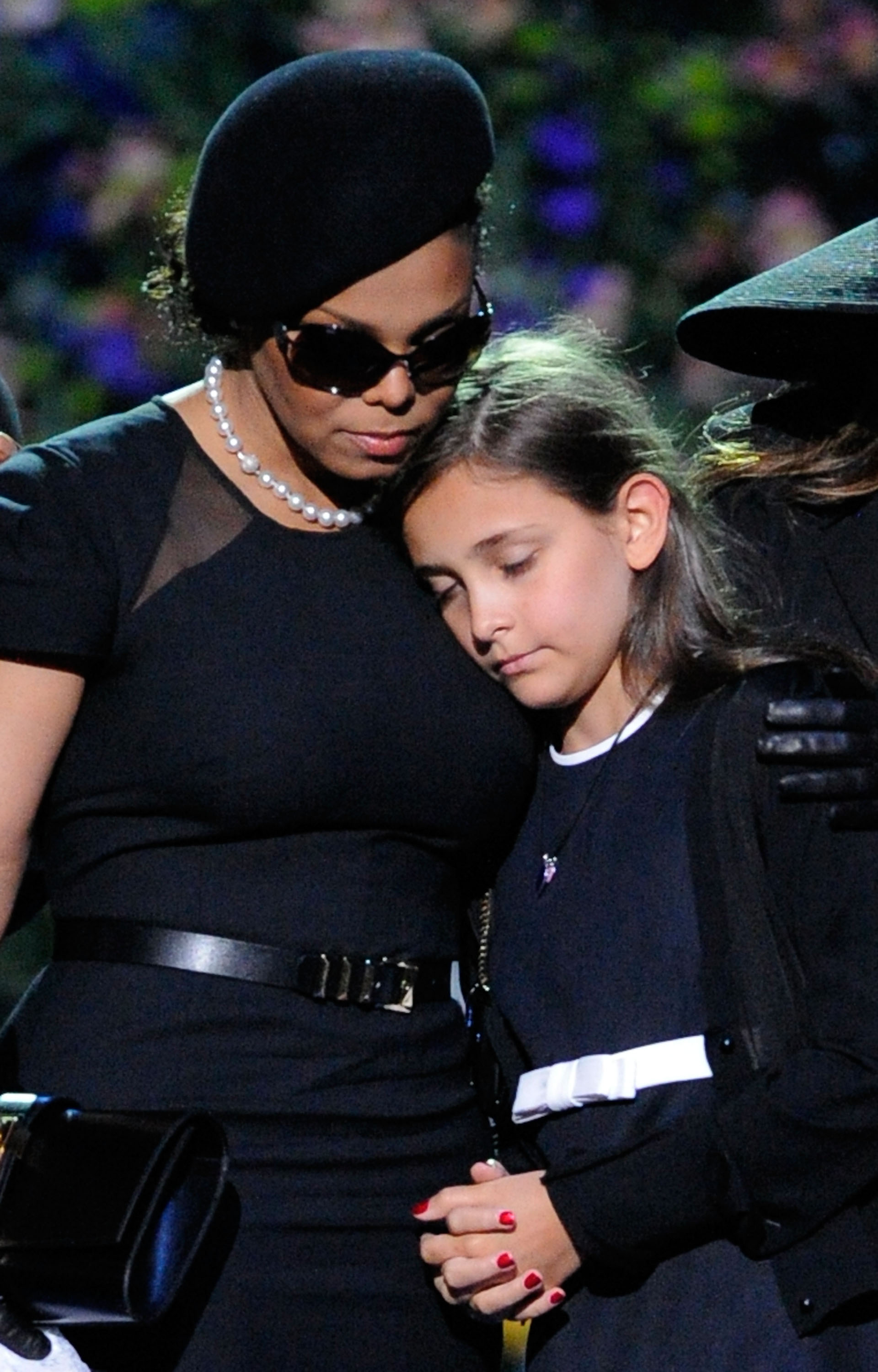 Janet and Paris Jackson hug onstage during the Michael Jackson public memorial service held at Staples Center on July 7, 2009 in Los Angeles, California. | Source: Getty Images
