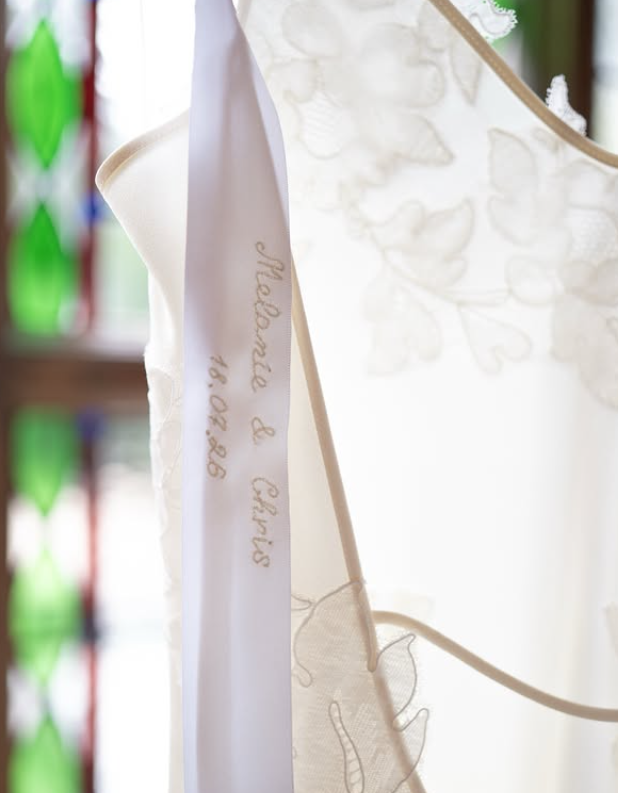 One of the most personal details was hidden inside the dress. An embroidered ribbon stitched with "Melanie & Chris" and their wedding date, July 18, 2026, added a sentimental touch that wasn't visible in the ceremony photos. | Source: Instagram/timmsy