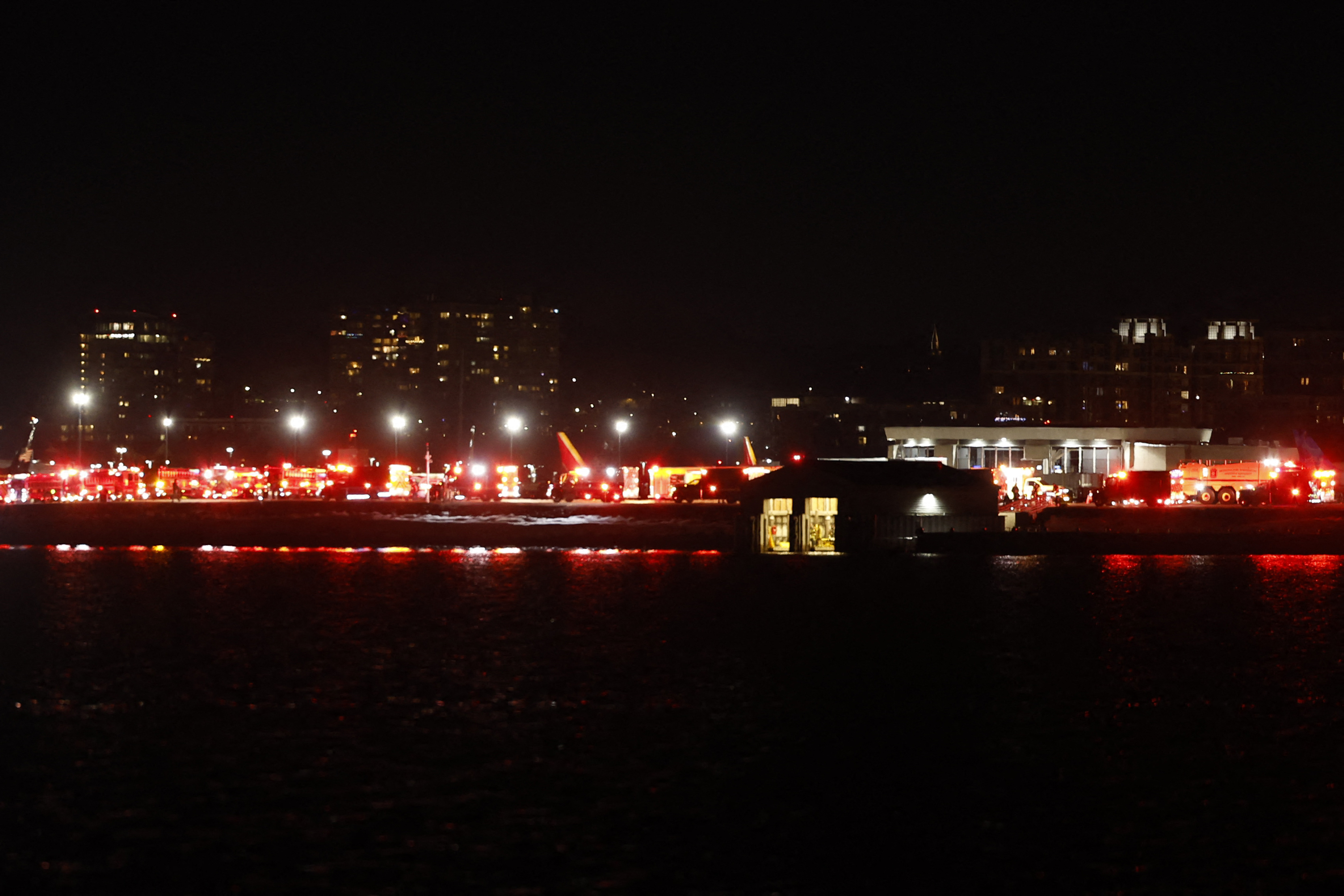 Lights from emergency vehicles are seen at Reagan National Airport in Washington, DC, after an air crash near the Potomac River on January 29, 2025 | Source: Getty Images