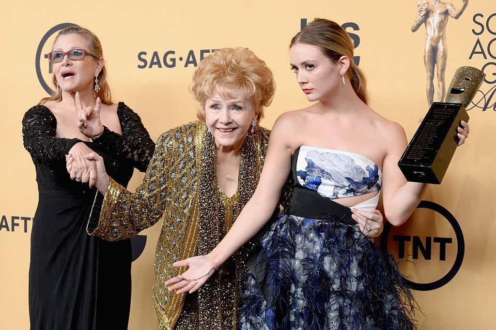 Debbie Reynolds and Carrie Fisher, pose with Billie Lourd at the 21st Annual Screen Actors Guild Awards  in 2015 in Los Angeles. | Source: Getty Images (Photo by Jeff Kravitz/FilmMagic)