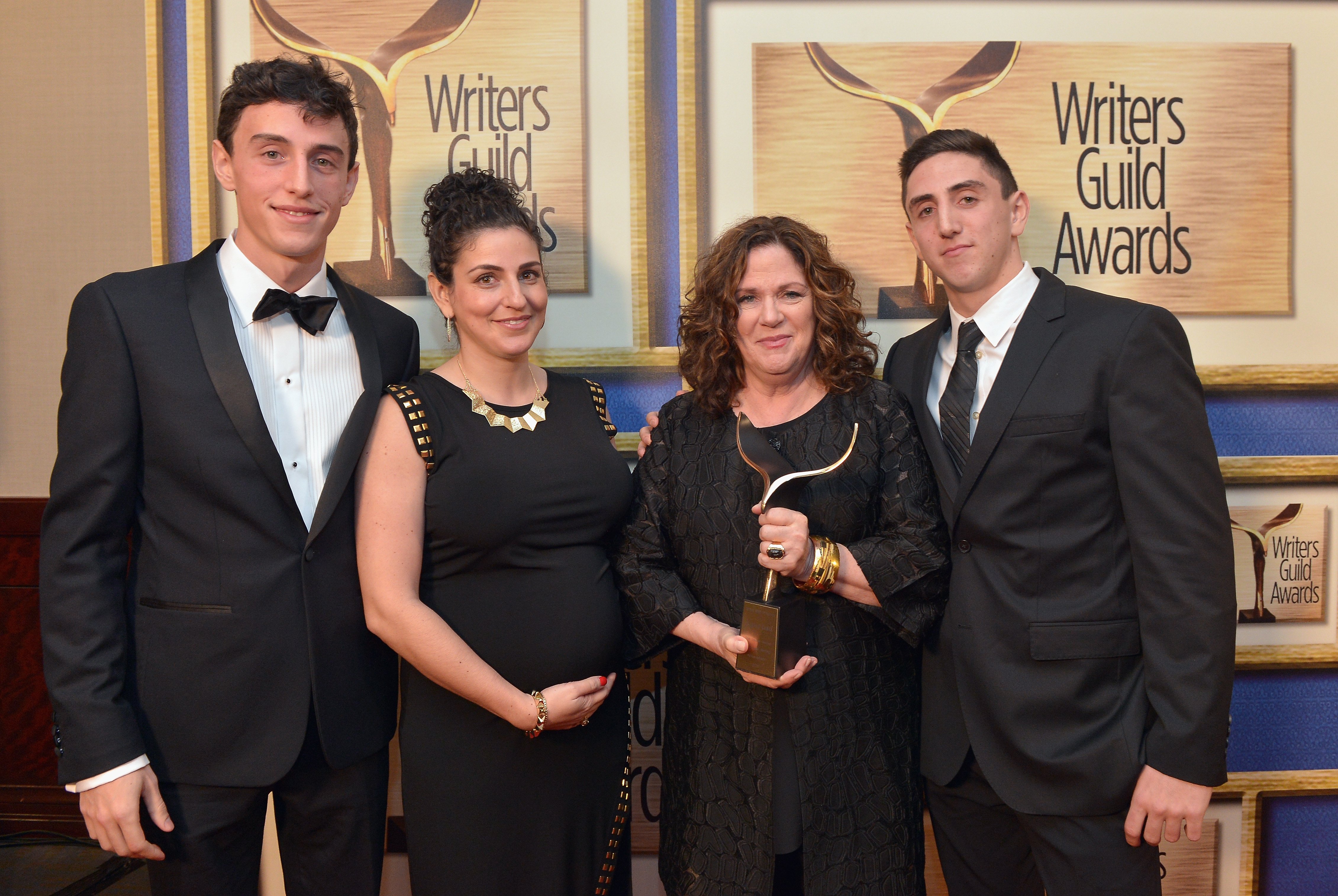 (L-R) Daniel Ramis, Violet Ramis, Erica Mann Ramis, and Julian Ramis pose with the Screen Laurel Award during the 2015 Writers Guild Awards L.A. Ceremony at the Hyatt Regency Century Plaza on February 14, 2015, in Century City, California | Source: Getty Images