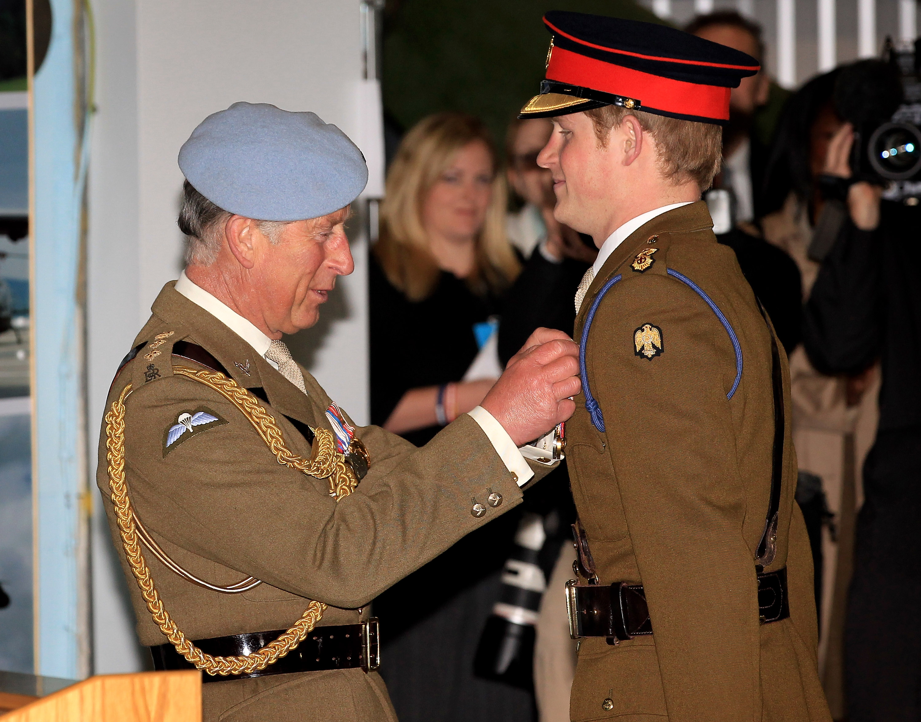 Prince Charles presents his son Prince Harry with his flying wings at Prince Harry's pilot course graduation at the Army Aviation Centre on May 7, 2010 in Andover, England | Source: Getty Images