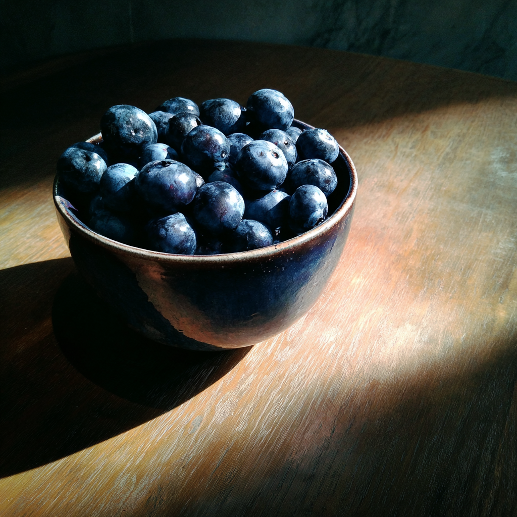 A bowl of blueberries on a table | Source: Midjourney
