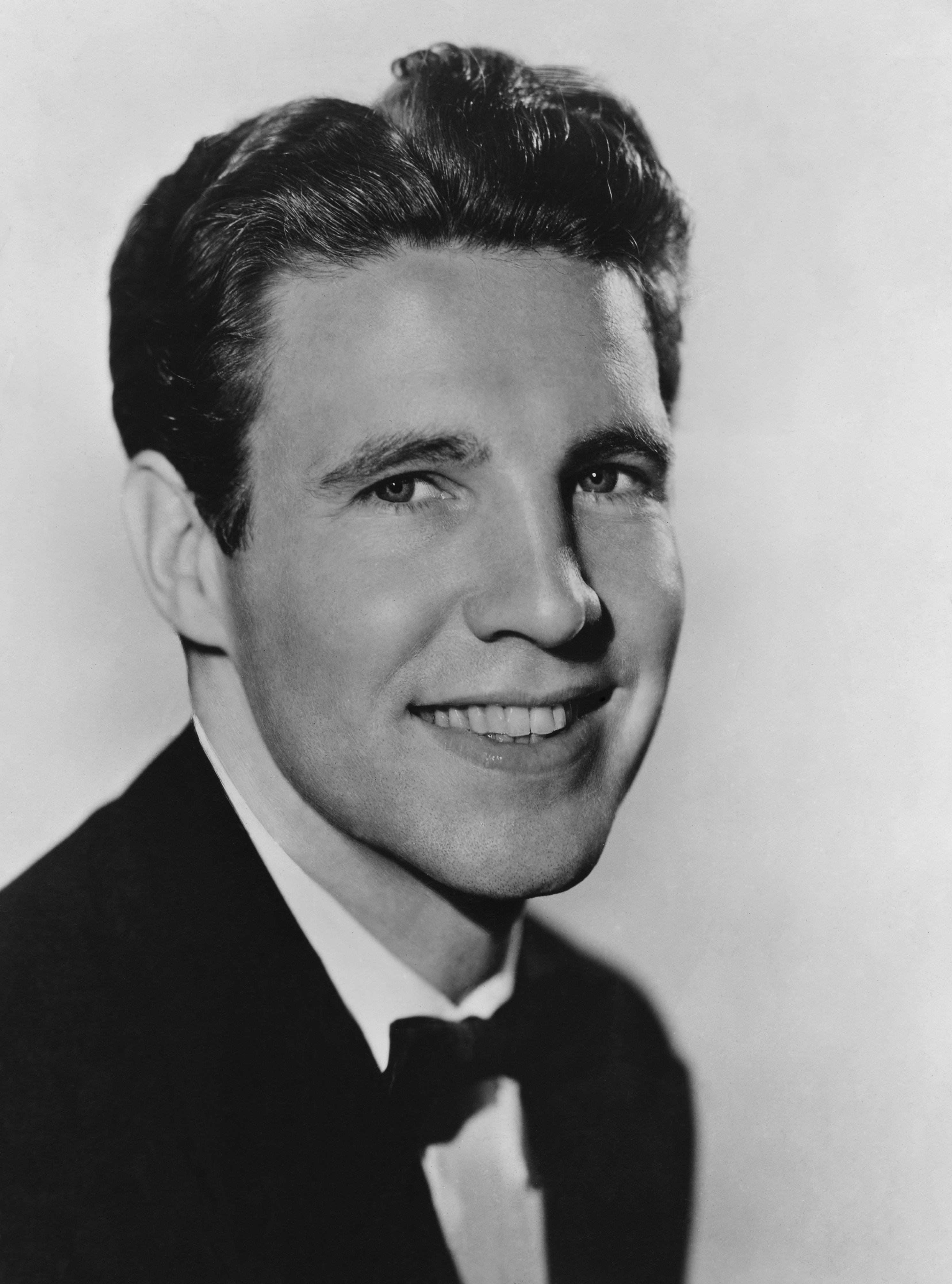 Ozzie Nelson smiling in a black-and-white unspecified photo. | Source: John Springer Collection/CORBIS/Getty Images