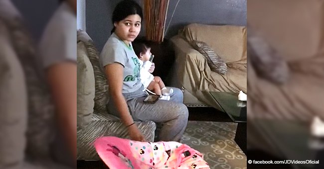 Husband caught wife holding their baby in her arms while continuing to push the rocker