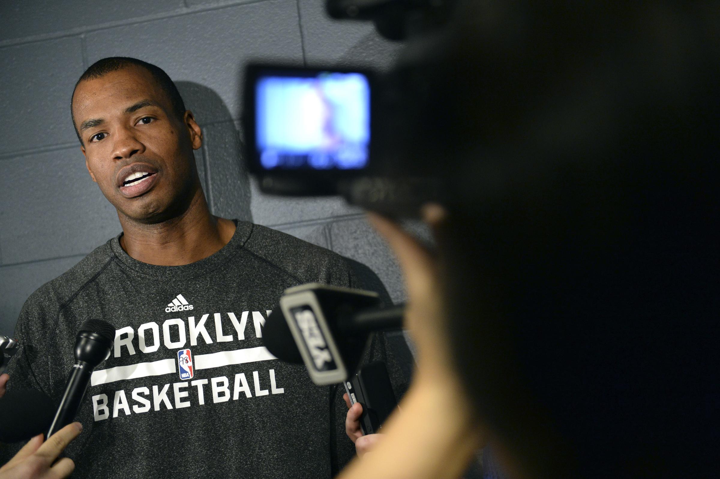 Jason Collins speaks to reporters before a Brooklyn Nets game in Denver on February 27, 2014 | Source: Getty Images