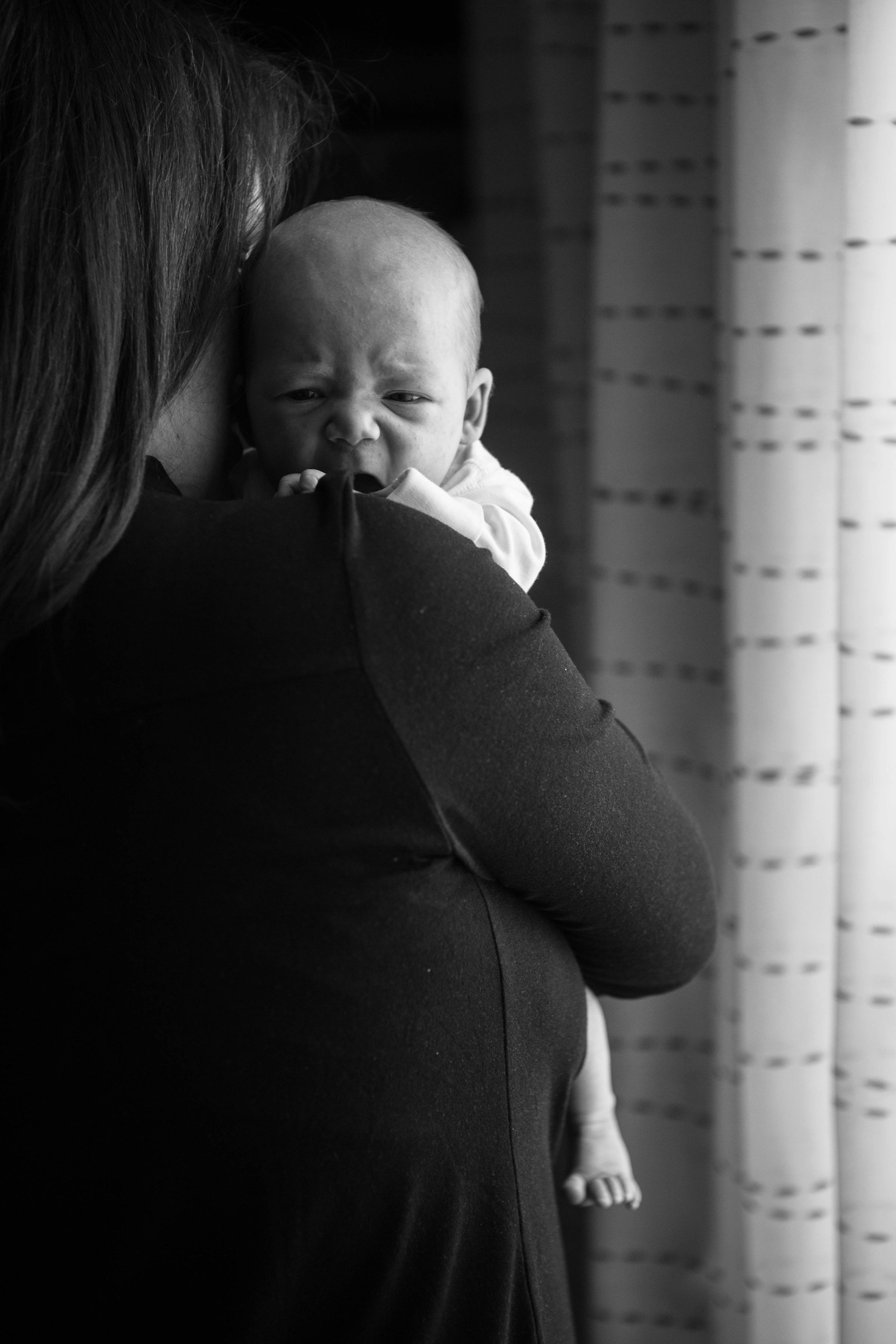 A closeup of a woman holding a crying baby | Source: Unsplash