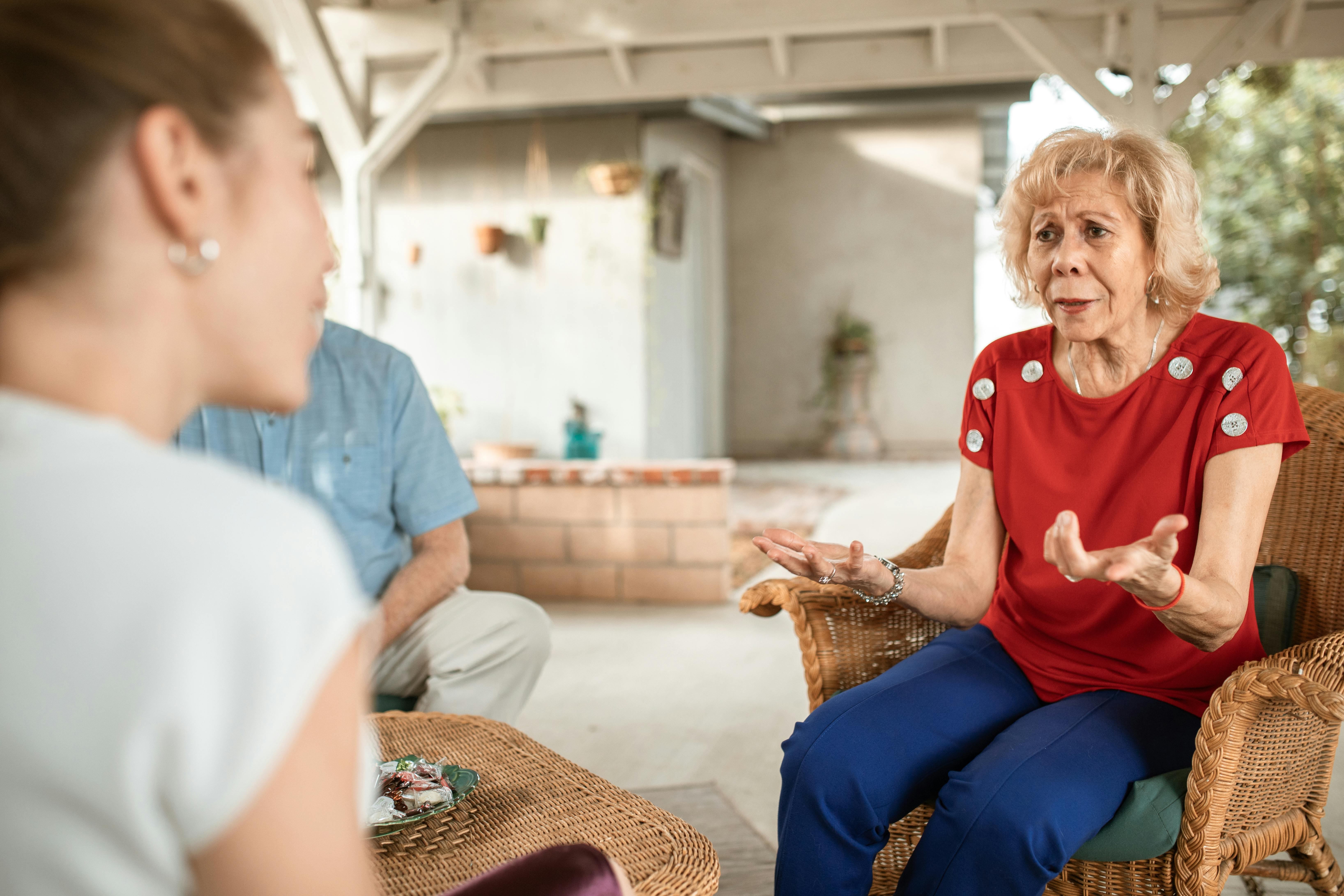 A middle-aged couple talking to their adult daughter | Source: Pexels