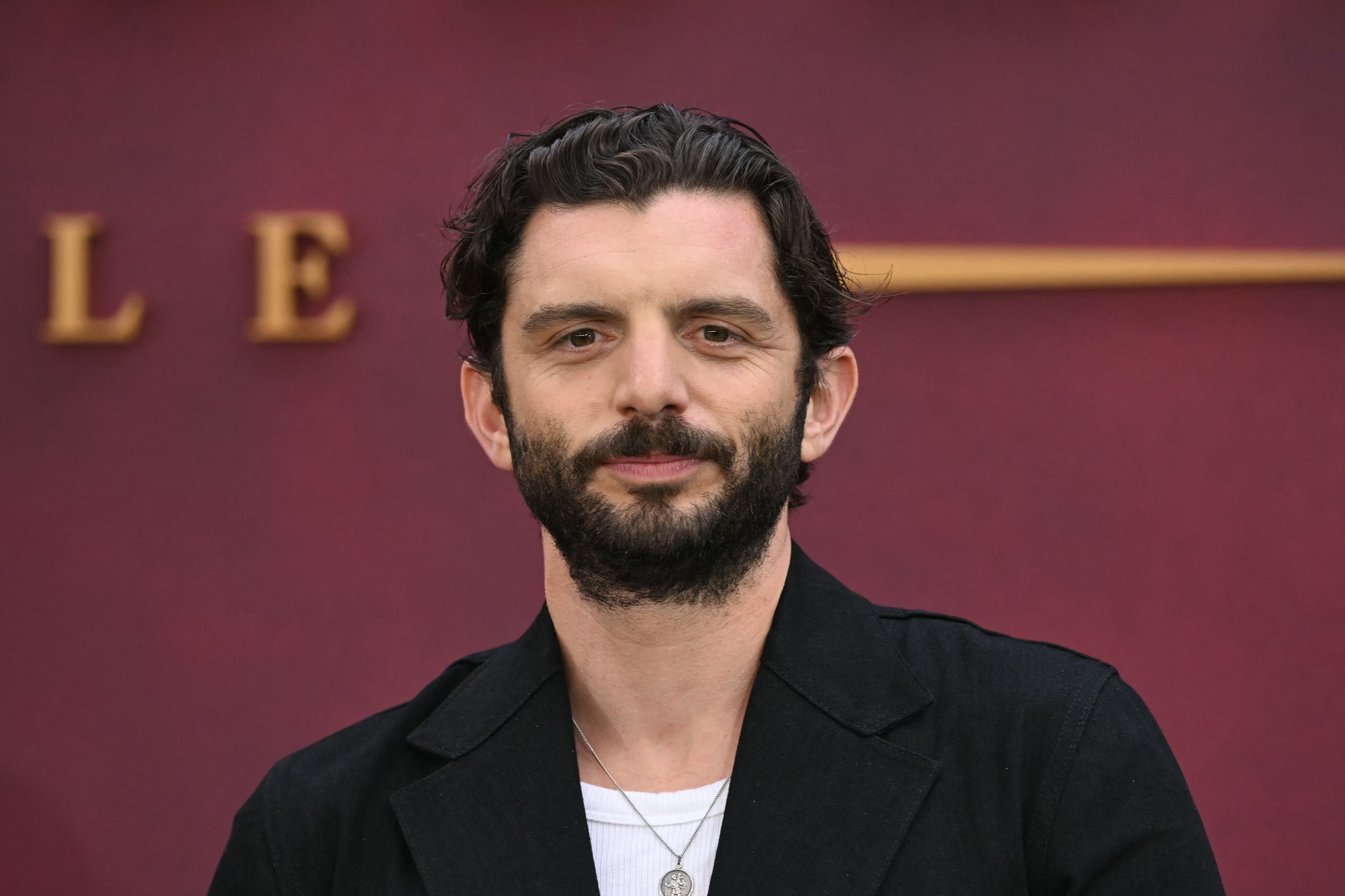 At the 2025 world premiere of "Downton Abbey: The Grand Finale" in London, Fox embraced a more refined and mature look. With a full beard, swept-back hair, and layered silver jewelry over a white tee and black suit, he projected the confident polish of a seasoned actor.