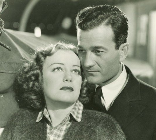 Judith Allen and Milburn Stone in Port of Missing Girls in 1938. | Source: Wikimedia Commons.