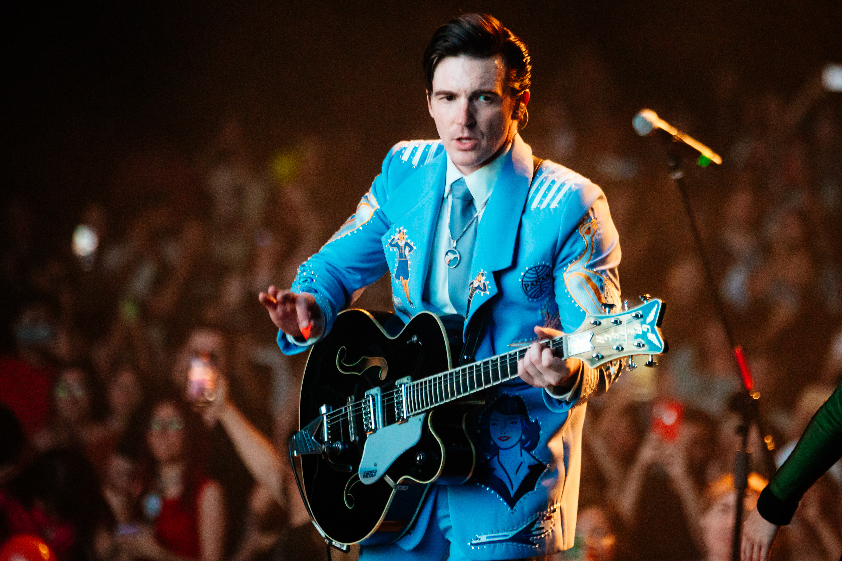 On stage in 2024, Bell had fully embraced his music career, performing in a retro blue rhinestone suit while playing guitar for a packed crowd. With slicked-back hair and confident stage presence, the former sitcom star now commands audiences as a full-time musician.