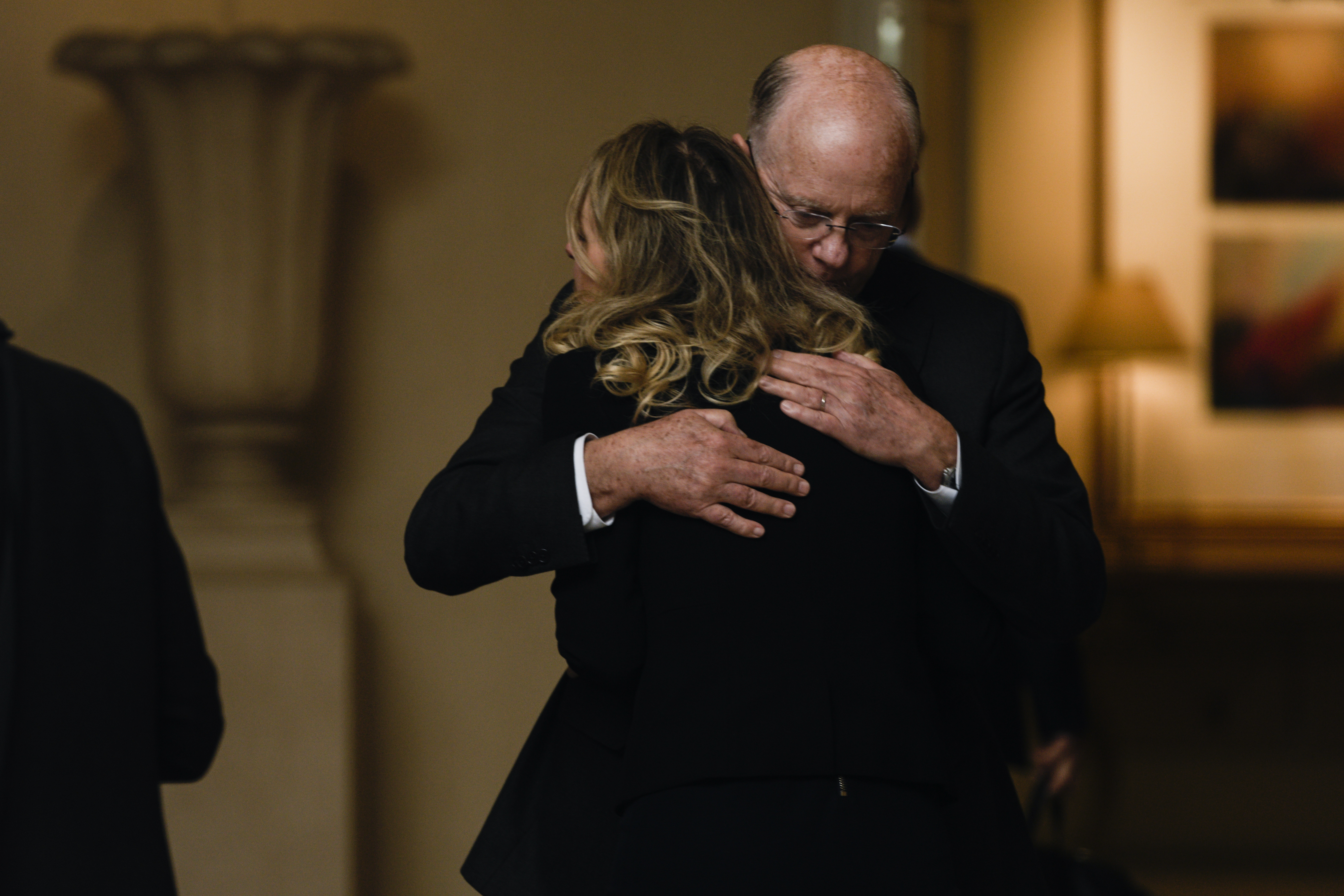 Former Theranos CEO Elizabeth Holmes hugs her father Christian Holmes IV after returning to her hotel following a hearing at the Robert E. Peckham U.S. Courthouse on March 17, 2023 in San Jose, California. | Source: Getty Images