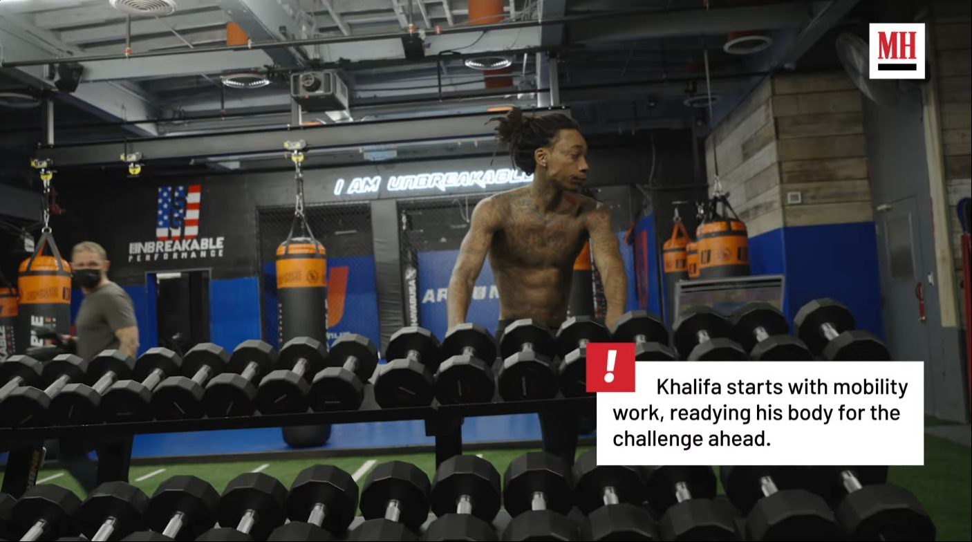 Wiz Khalifa begins his workout with mobility exercises designed to loosen his muscles and prepare his body for training. | Source: YouTube/Men's Health