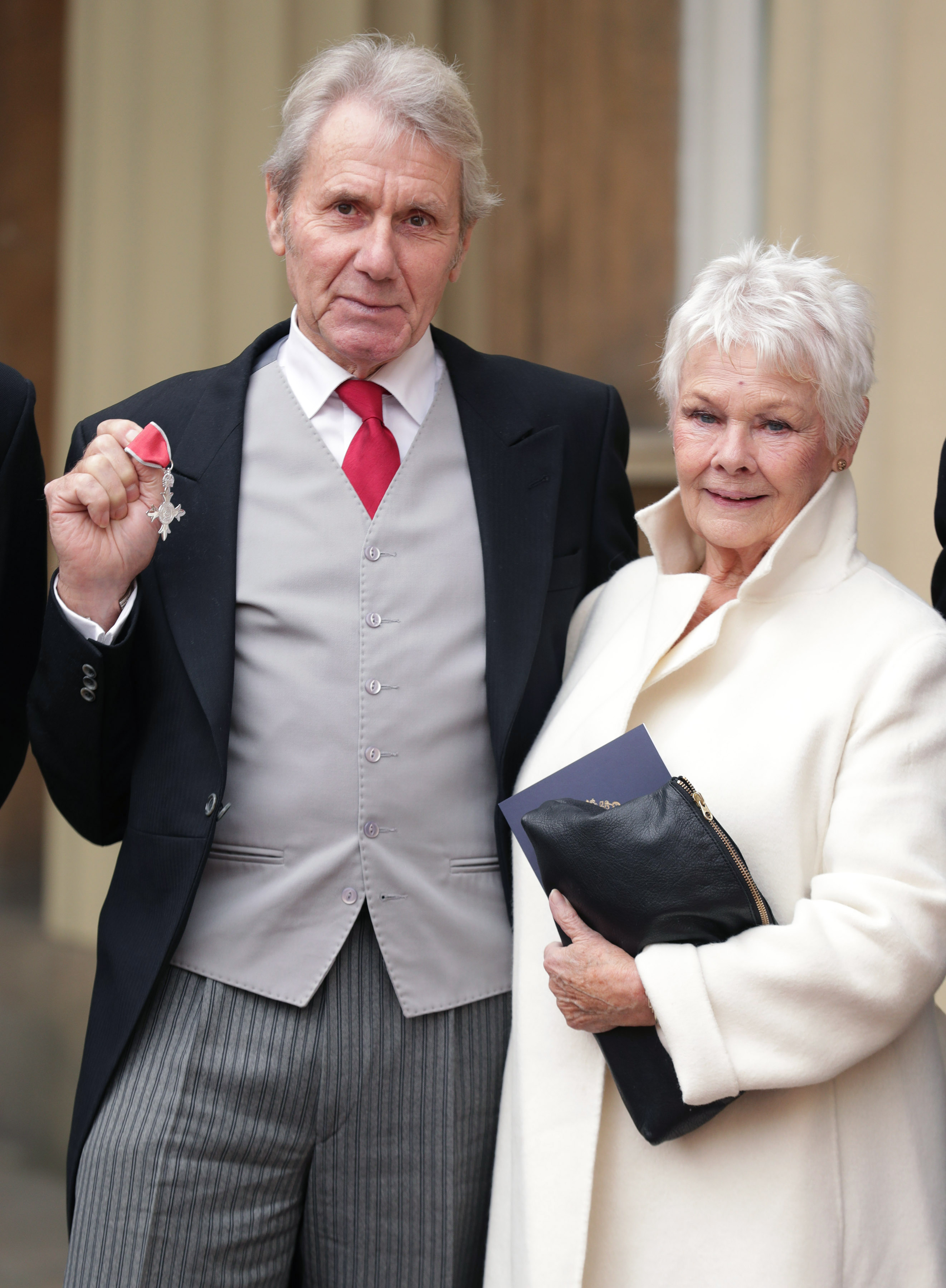 Dame Judi Dench and David Mills with his MBE which he received from the Prince of Wales during an Investiture ceremony at Buckingham Palace on November 18, 2016 in London, England. | Source: Getty Images