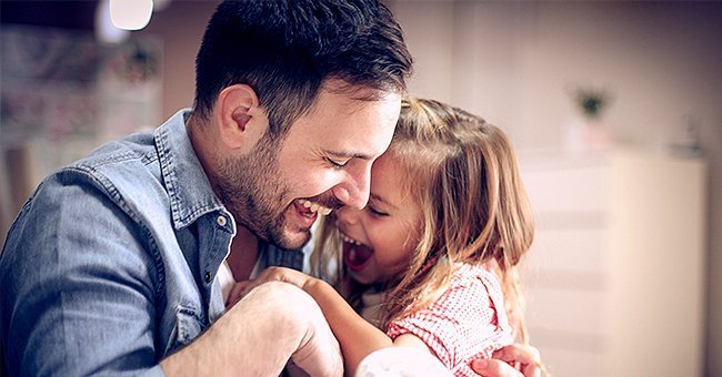 A father and his daughter laughing together.| Photo: Shutterstock.