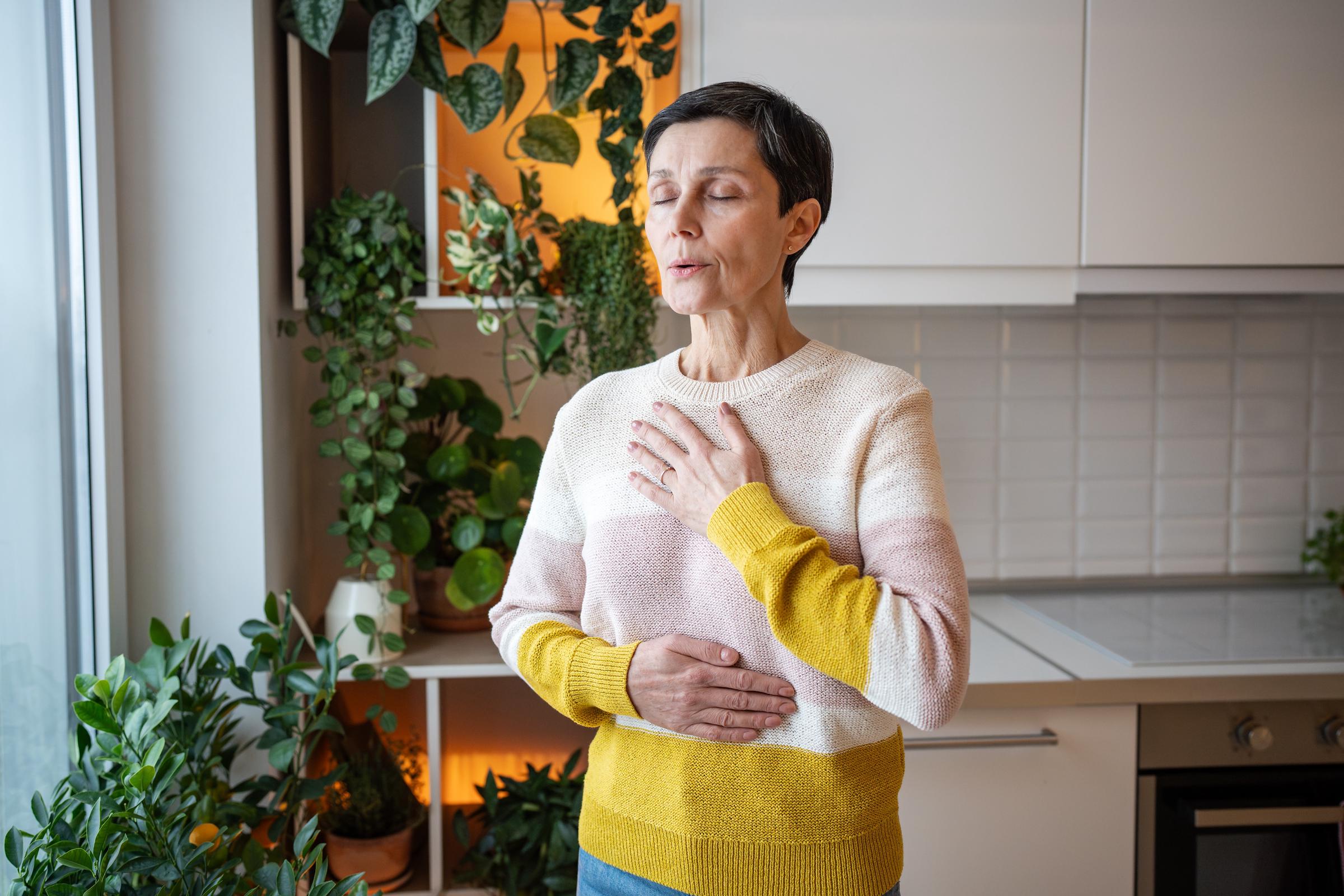 Woman performing a breathing exercise | Source: Shutterstock
