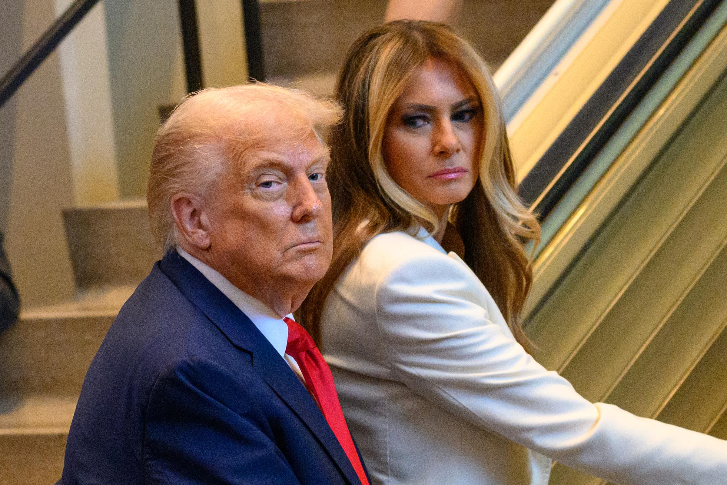 Melania Trump glances back with a slight side-eye as Donald Trump remains stoic. | Source: Getty Images