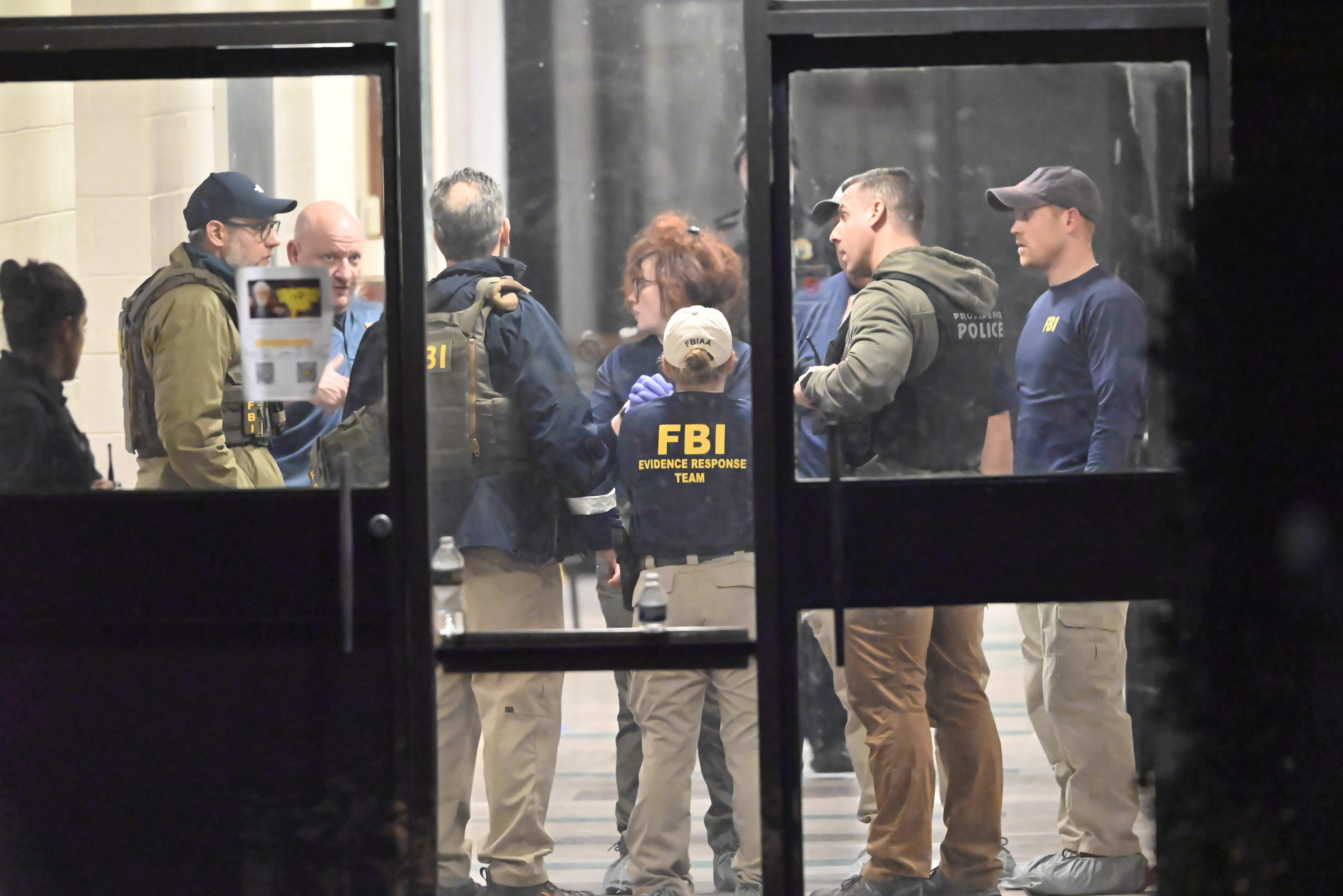 Members of the FBI Evidence Response Team collect evidence and mark the area near a body at Brown University on December 13, 2025, in Providence, Rhode Island | Source: Getty Images