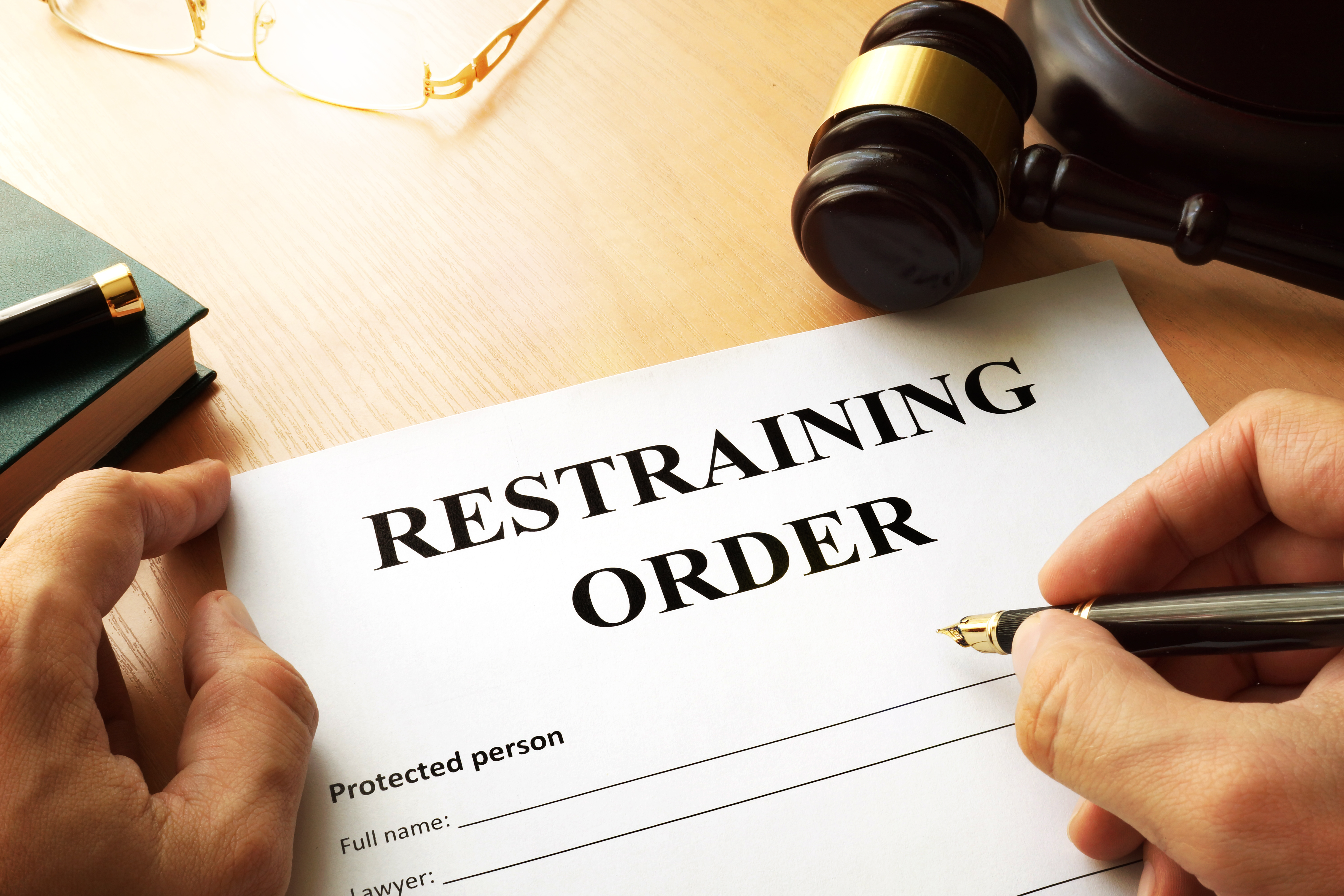 A person filling out a restraining order | Source: Getty Images