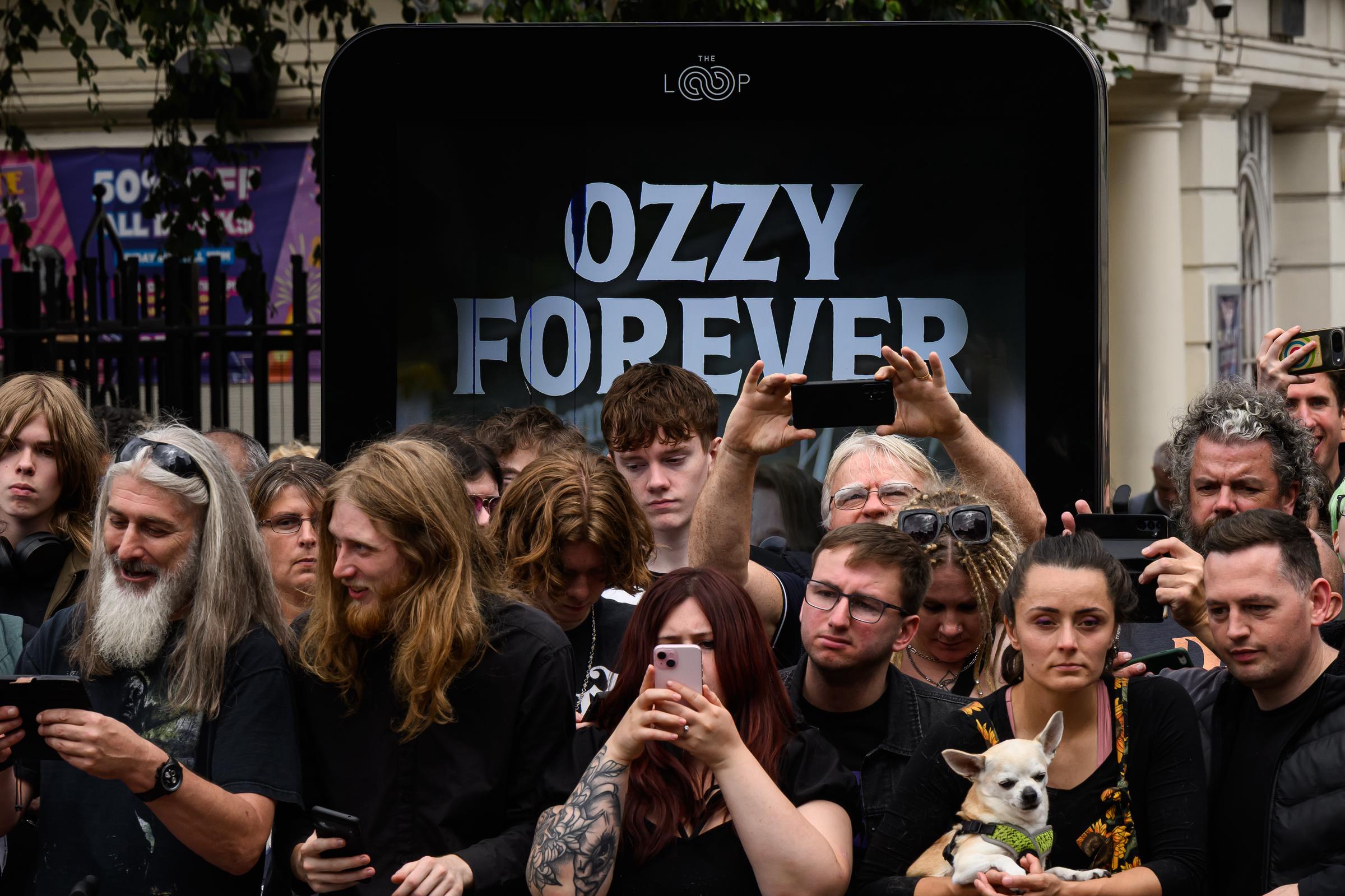 Fans gather at Black Sabbath Bridge after members of the Osbourne family visit to view tributes to the late Ozzy Osbourne as his funeral cortege travelled through his home city of Birmingham on July 30, 2025 in Birmingham, England. | Source: Getty Images