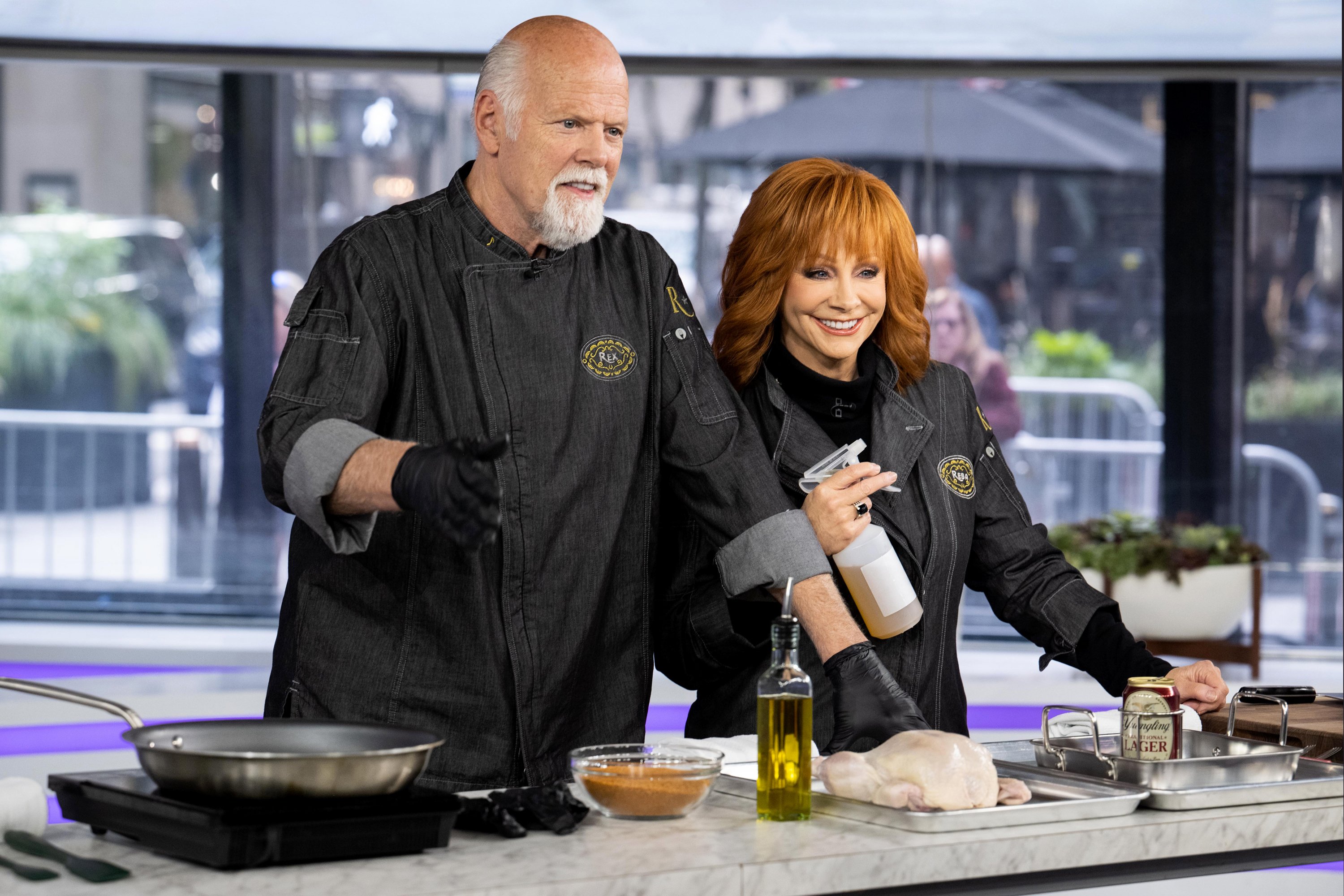 On October 10, they appear on the set of the "Today show," standing side by side at a cooking station. Both wear chef jackets; McEntire holds a spray bottle while Linn gestures with one hand.