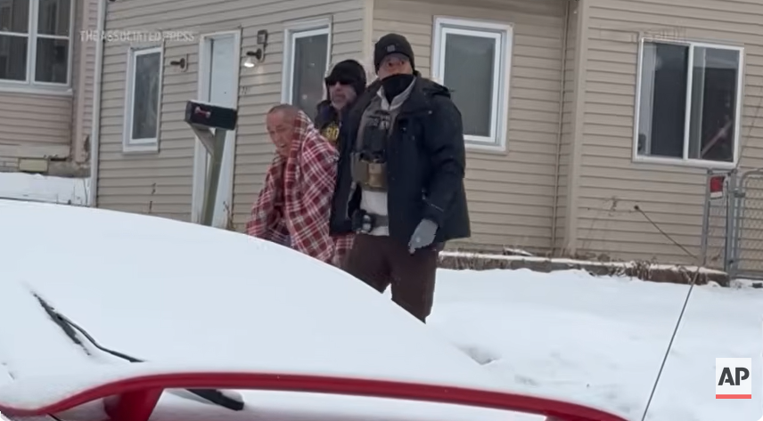 ICE agents lead ChongLy "Scott" Thao out of his house, from a post dated January 20, 2026 | Source: Youtube/AssociatedPress