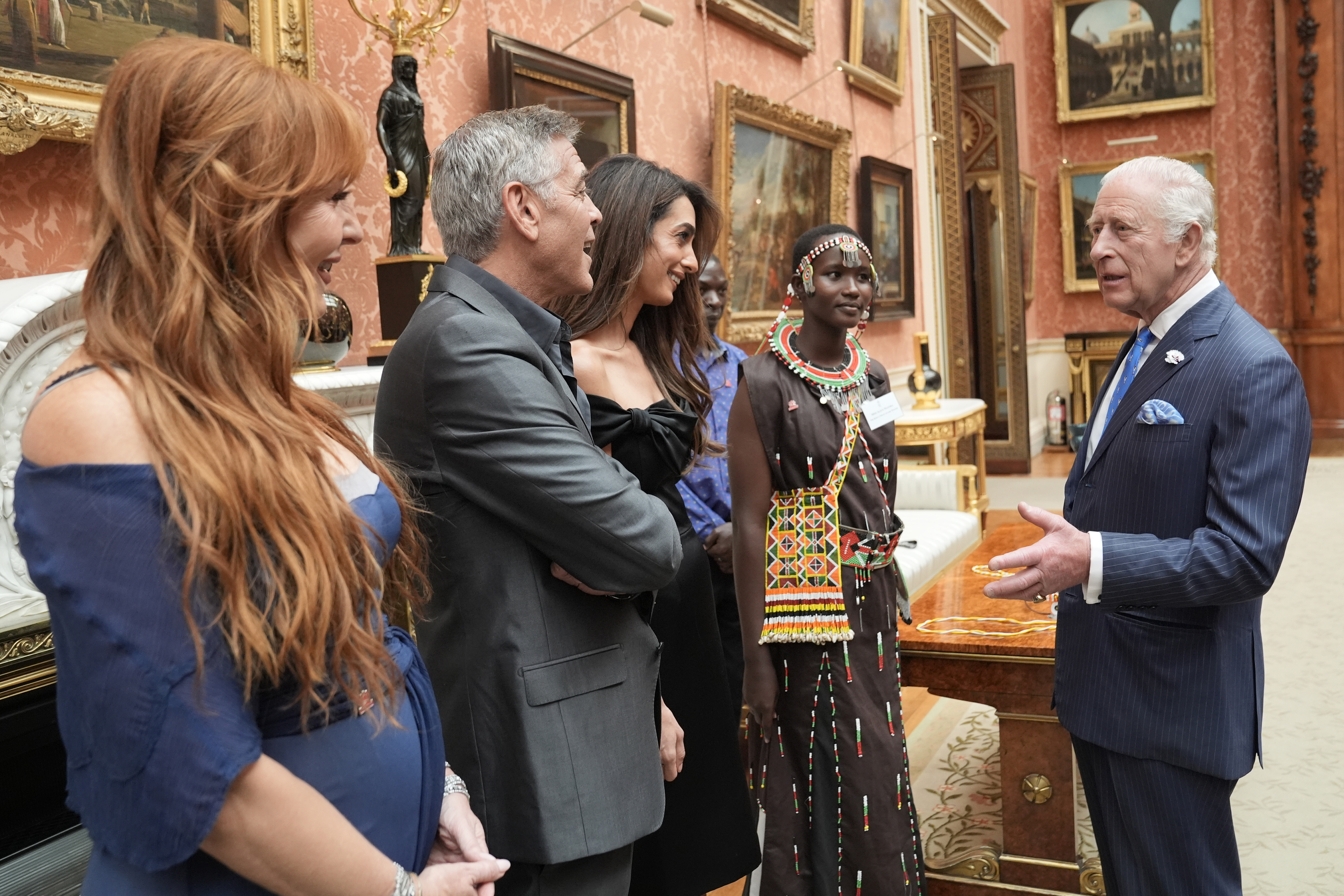 King Charles III speaks with Charlotte Tilbury, George, and Amal Clooney during a reception for the winners of the King's Trust Awards at Buckingham Palace on June 25, 2025 in London, England | Source: Getty Images