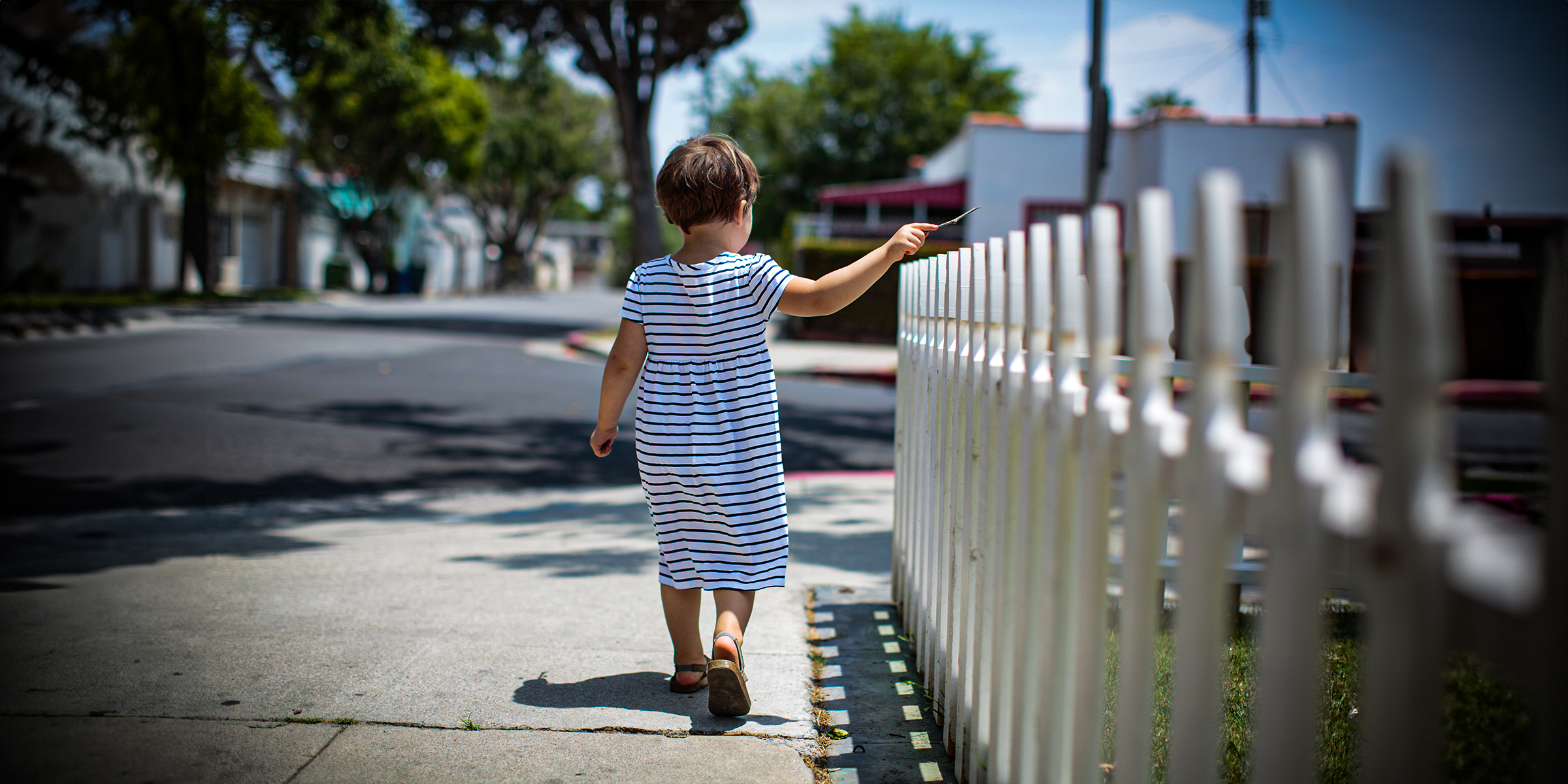 A girl walking near a fence | Source: Shutterstock