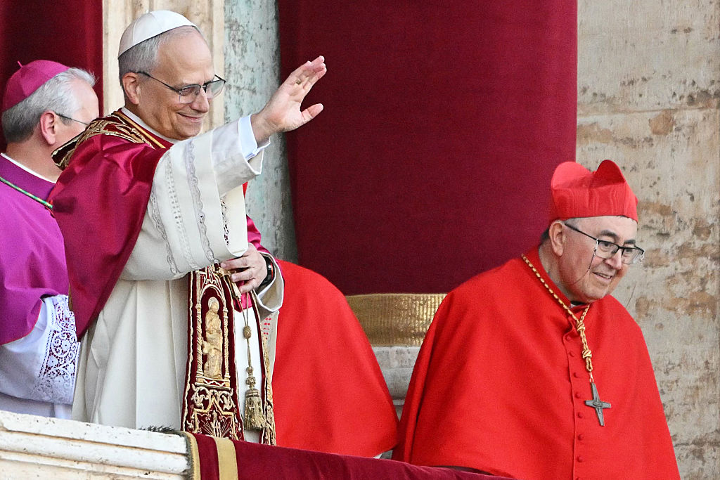Newly elected Pope Leo XIV, Robert Francis Prevost (C) gestures as he addresses the crowd from the main central loggia balcony of the St Peter's Basilica for the first time, after the cardinals ended the conclave, in The Vatican, on May 8, 2025