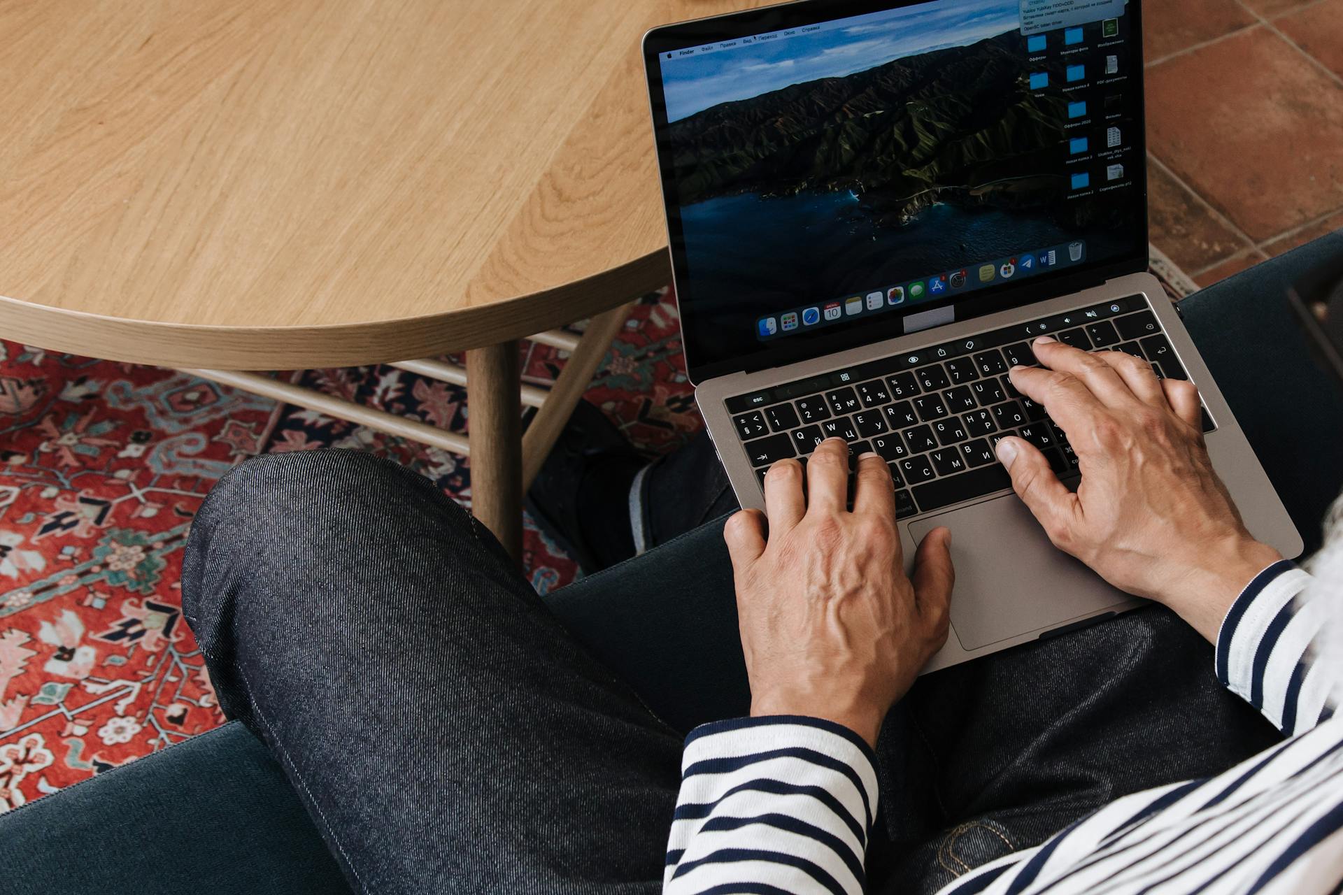 A closeup of a man working on his laptop from home | Source: Pexels