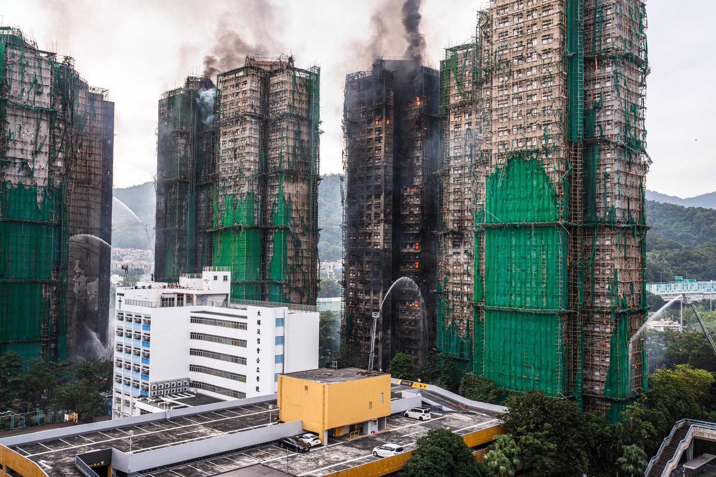 Smoke continues to rise from multiple high-rise towers in Tai Po, Hong Kong, a day after the deadly fire on November 26, 2025 | Source: Getty Images