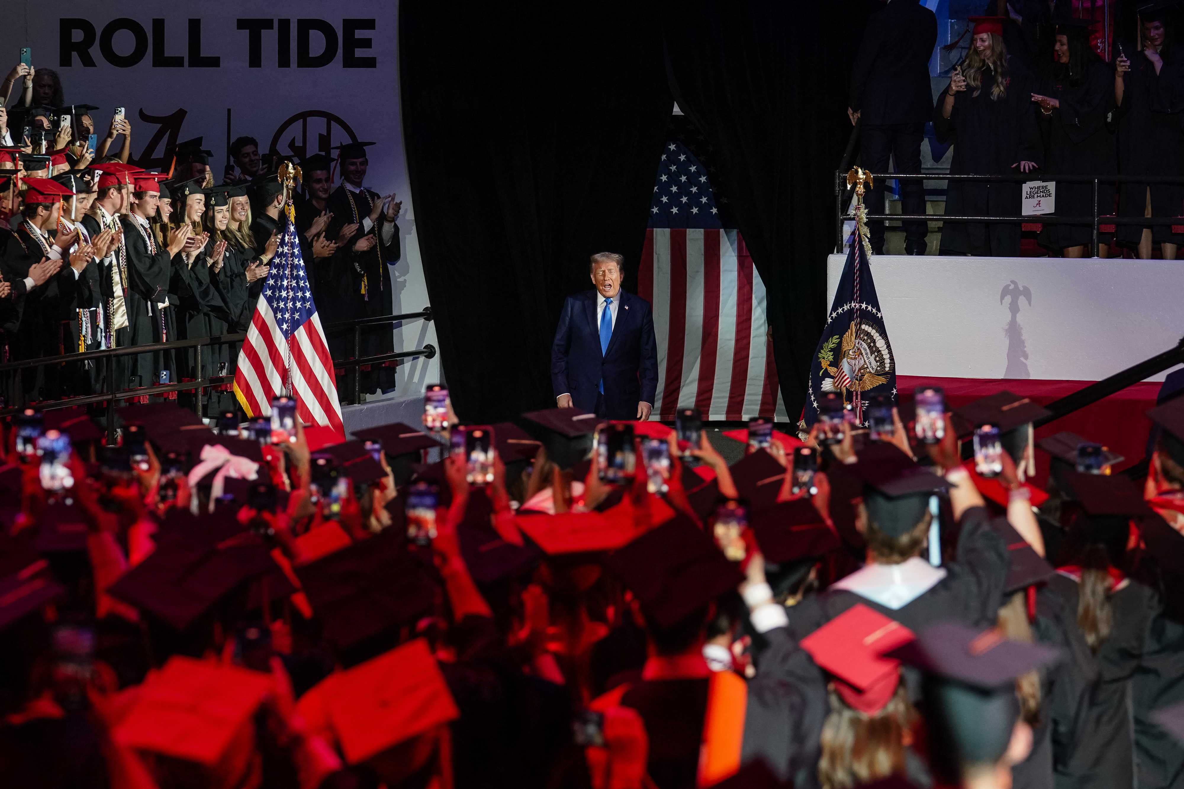 Attendees applaud U.S. President Donald Trump as he arrives to deliver commencement remarks at the University of Alabama in Tuscaloosa on May 1, 2025 | Source: Getty Images