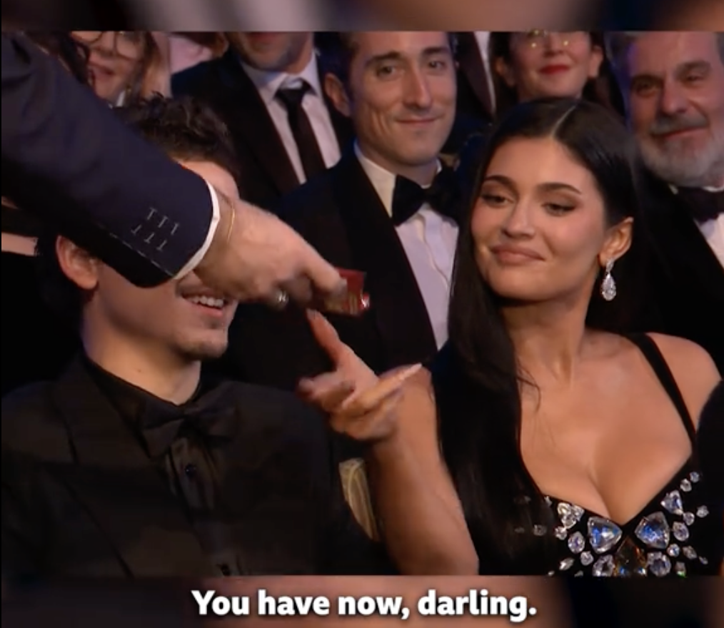Alan Cumming offering a snack to Kylie Jenner at the 79th BAFTA Film Awards dated February 22, 2026 | Source: TikTok/bbc