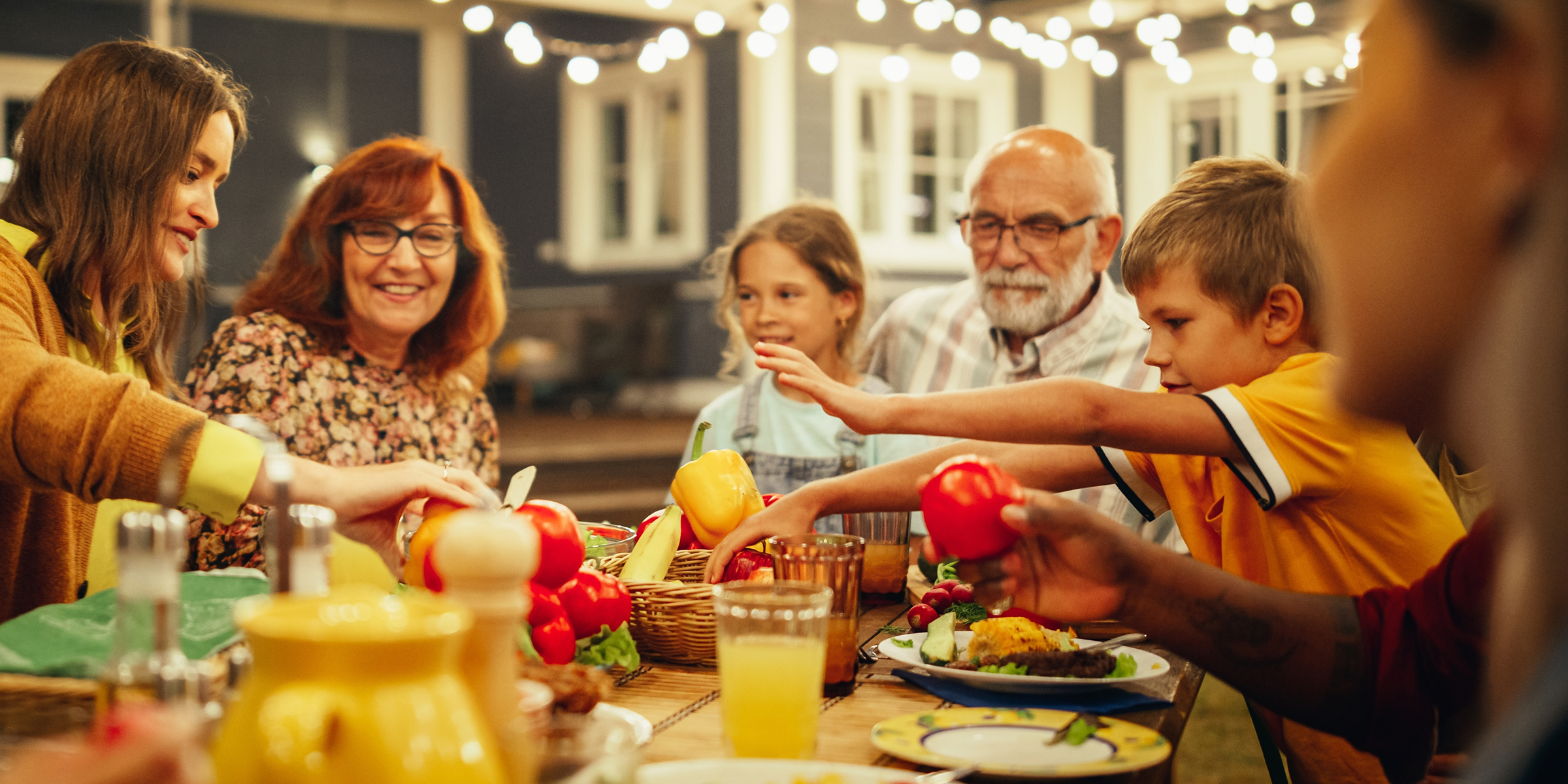 Happy family enjoying dinner | Source: Shutterstock