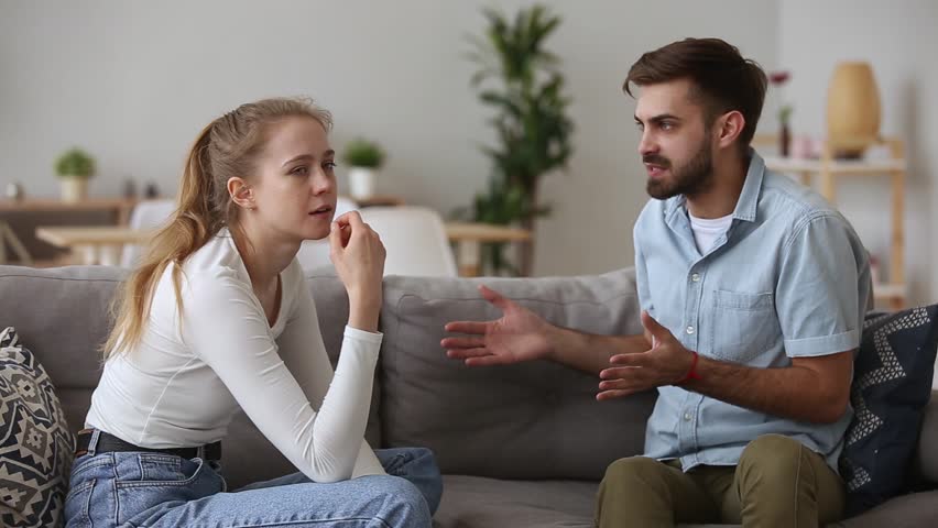 A man and a woman having an argument in their living room | Photo: Shutterstock