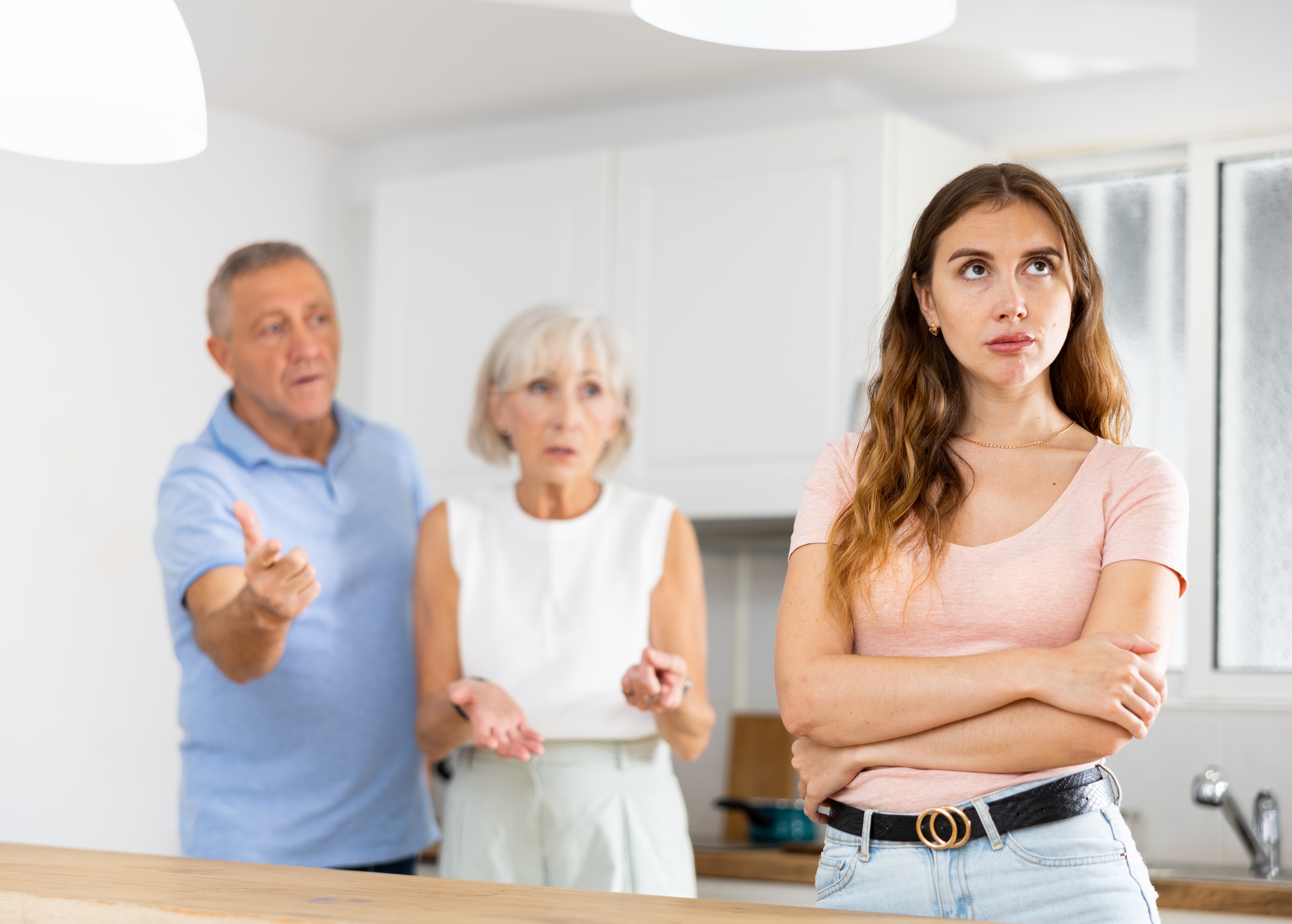 Parents lecturing their adult daughter at home | Source: Shutterstock