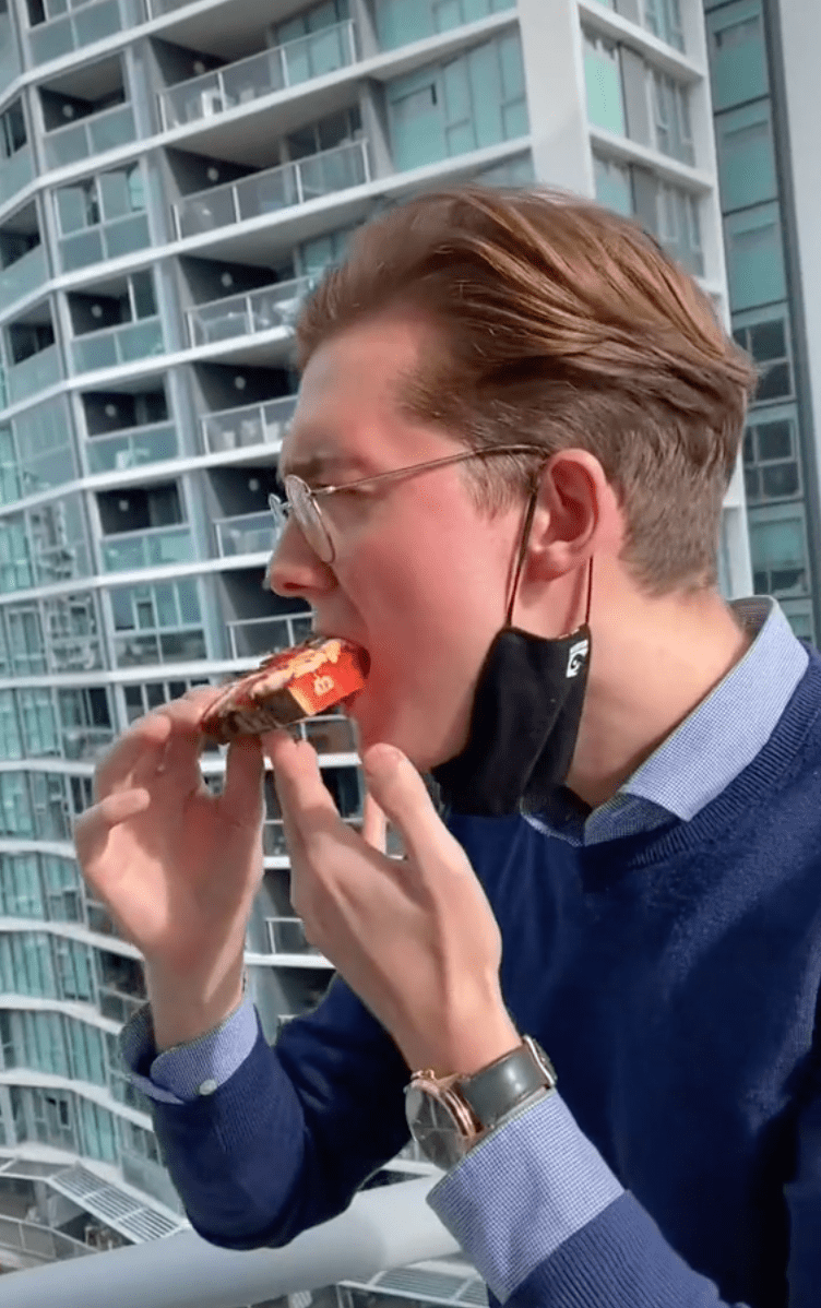 A man from Dominos bites into the watermelon pizza | Photo: TikTok/dominosau