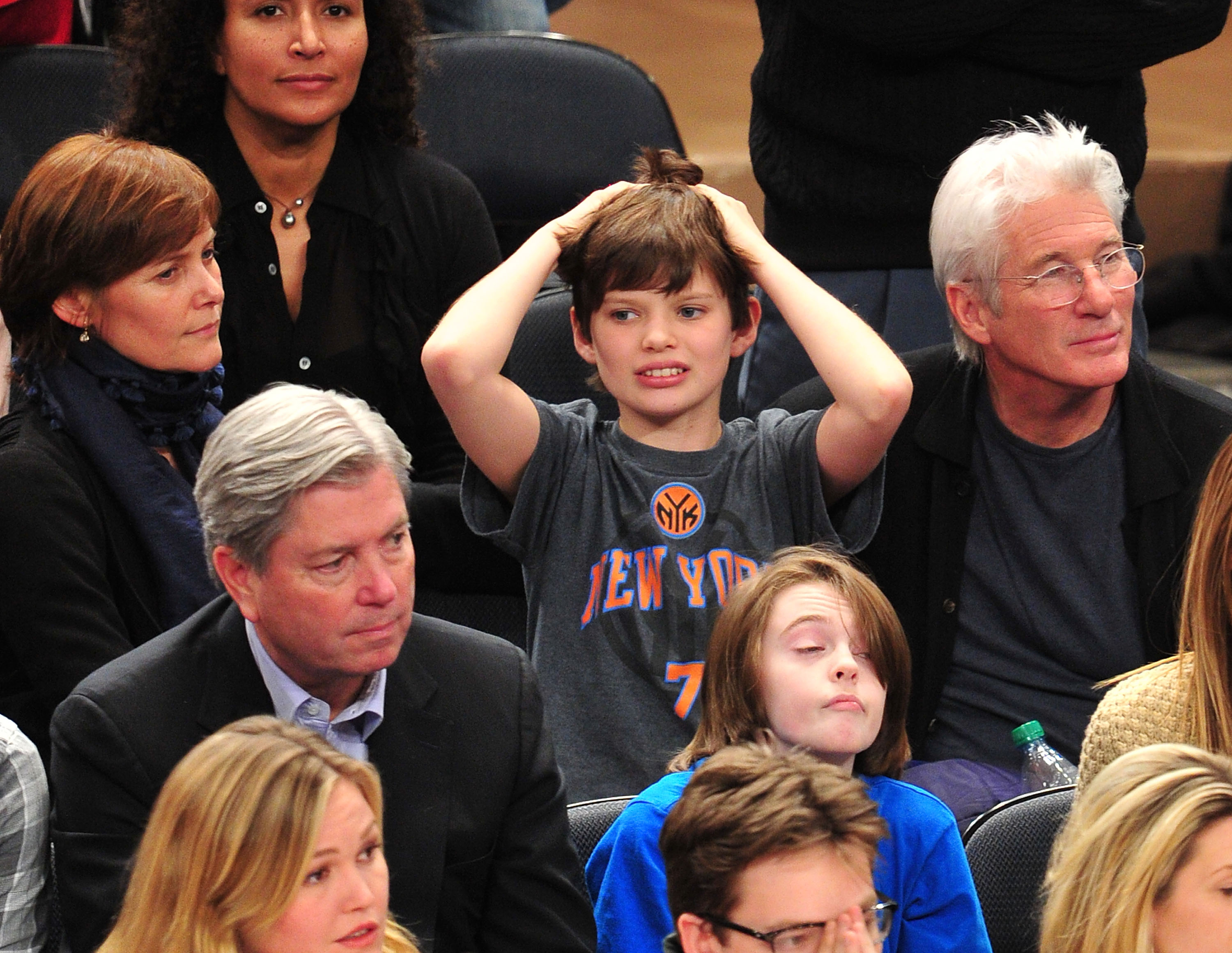 A young Homer James Gere reacts as he watches the Chicago Bulls VS New York Knicks game with his parents Carey Lowell and Richard Gere at Madison Square Garden in New York City on February 2, 2012. | Source: Getty Images