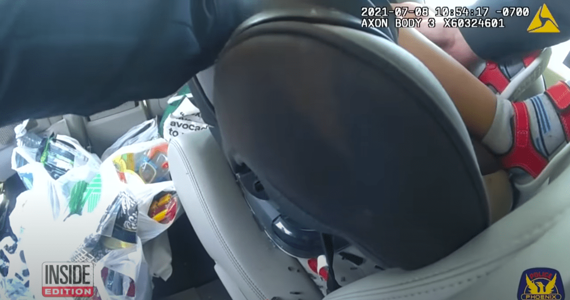 Screenshot of officer taking baby out of hot vehicle. | Source: YouTube/ Inside Edition