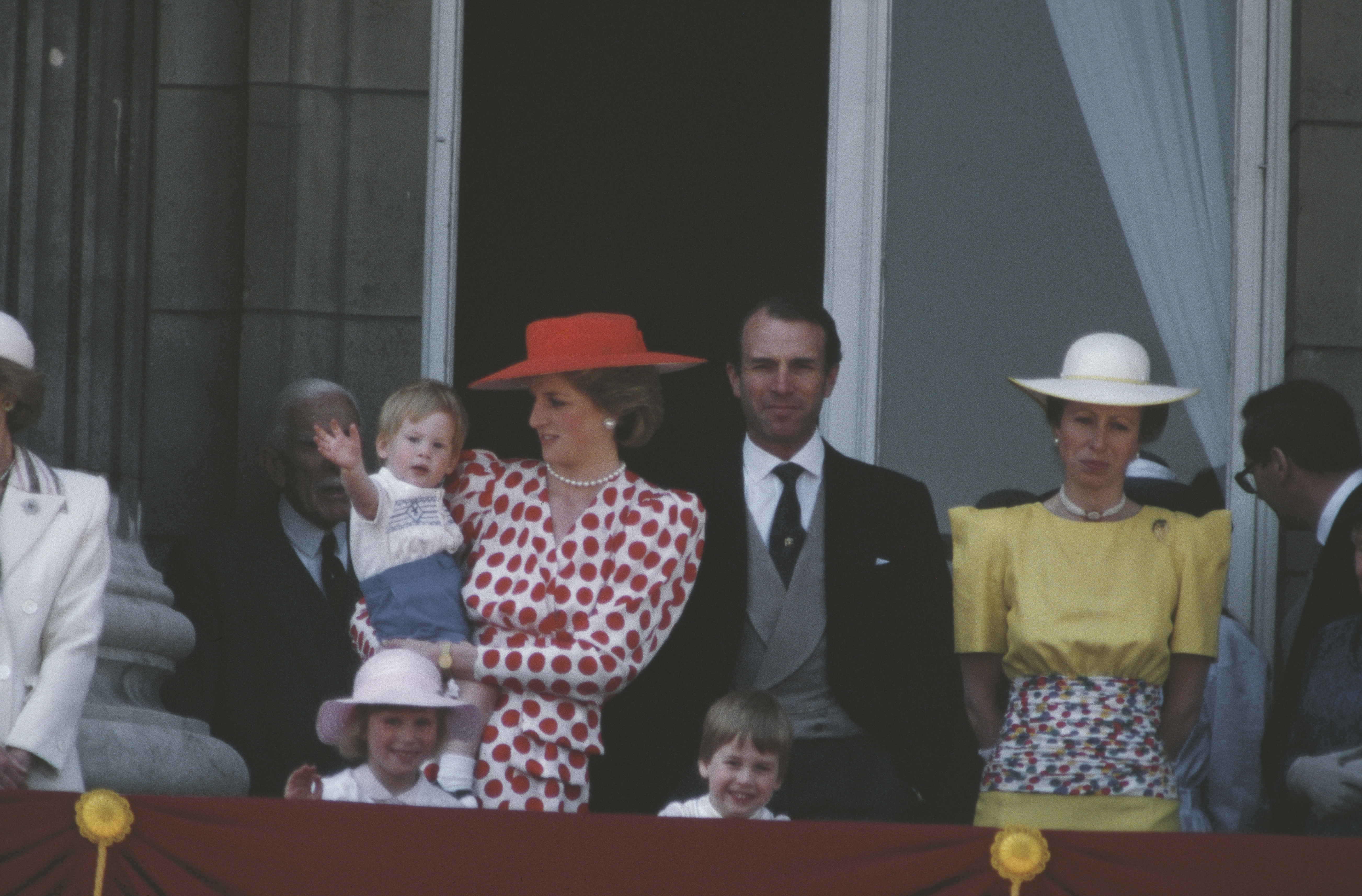 Princess Diana holding Prince Harry with Prince William, Princess Anne and Mark Phillips on the balcony for the Trooping the Colour ceremony in June 1986. | Source: Getty Images