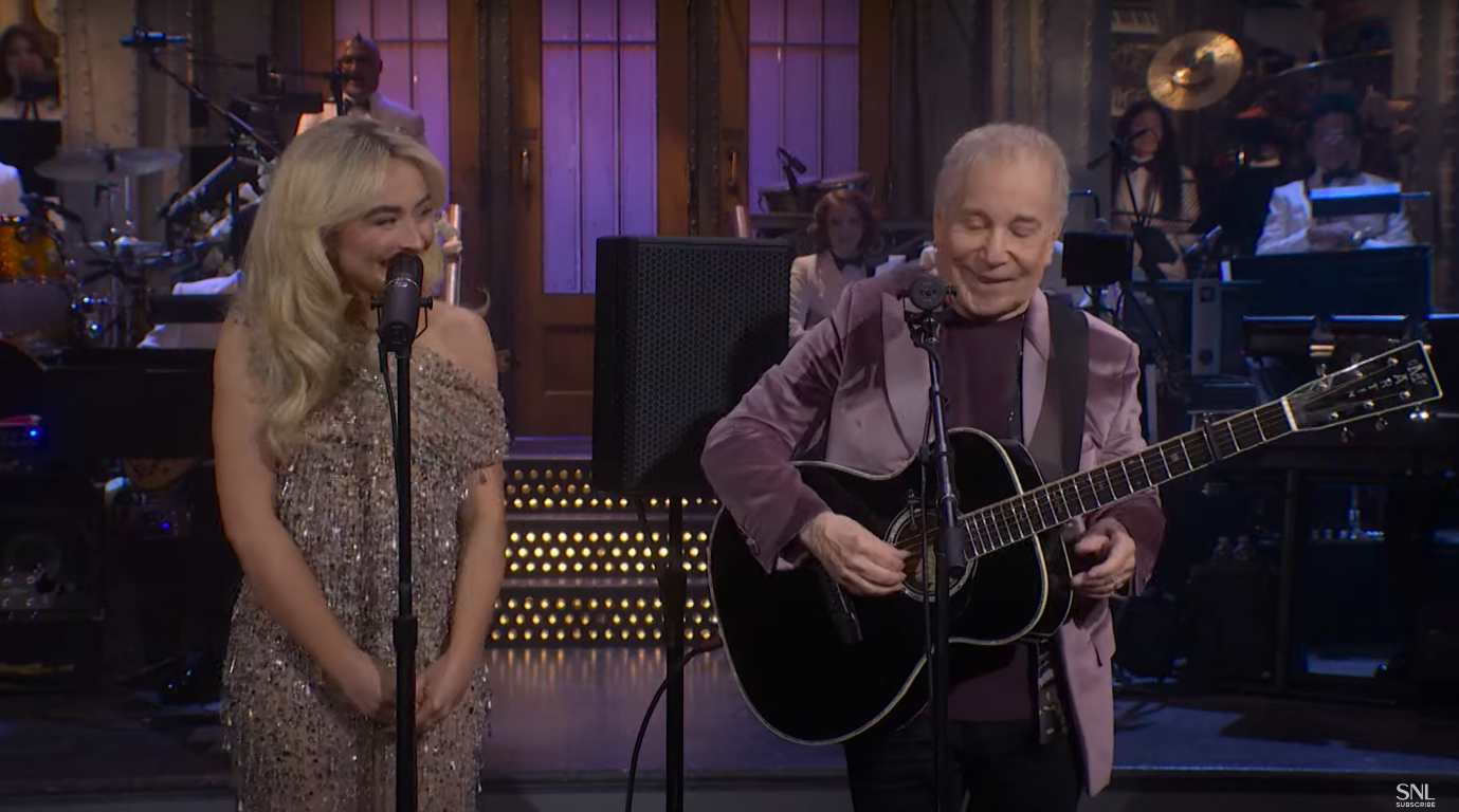 Sabrina Carpenter and Paul Simon on stage during "SNL50: The Anniversary Special." | Source: YouTube/Saturday Night Live