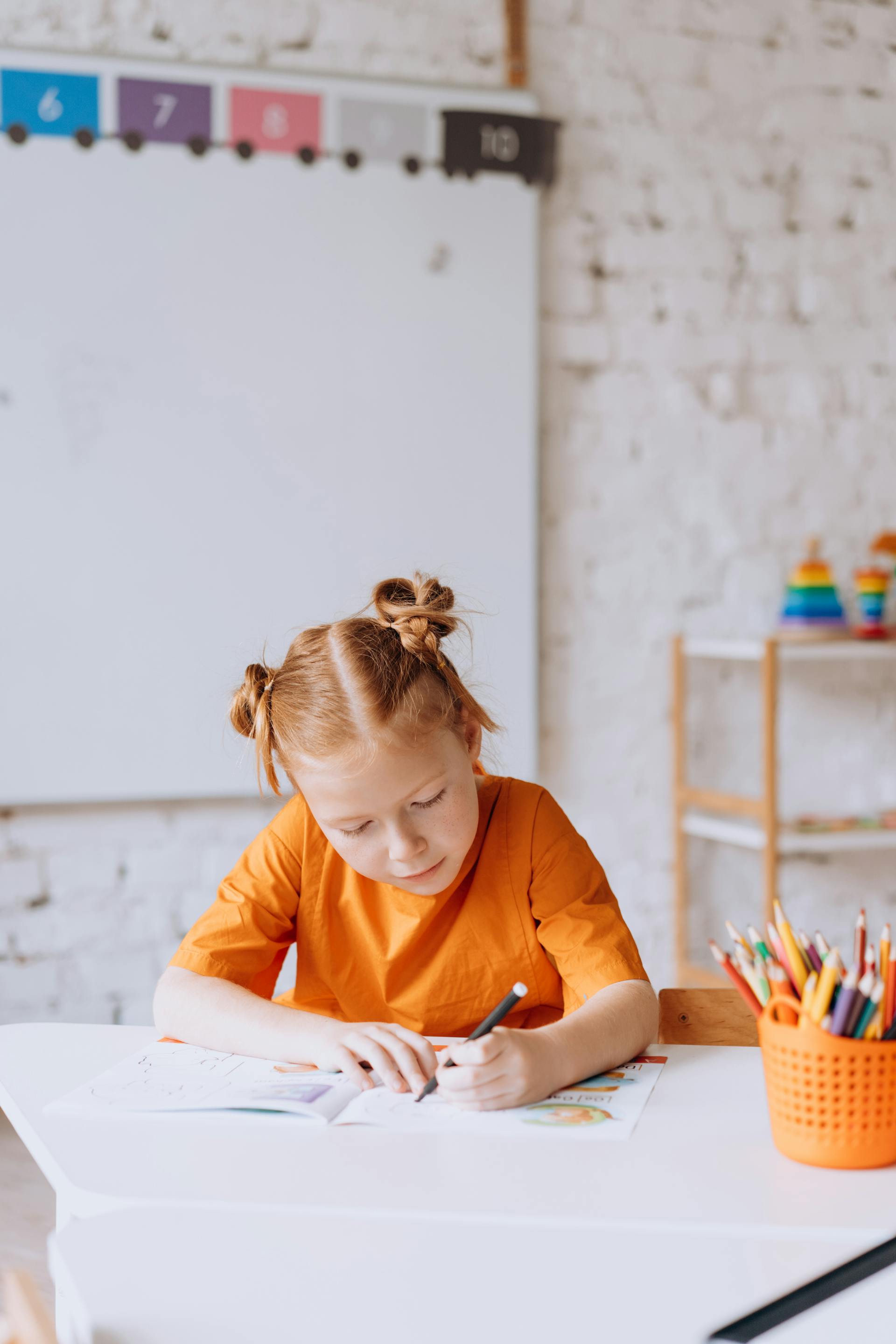 A little girl coloring on a book | Source: Pexels